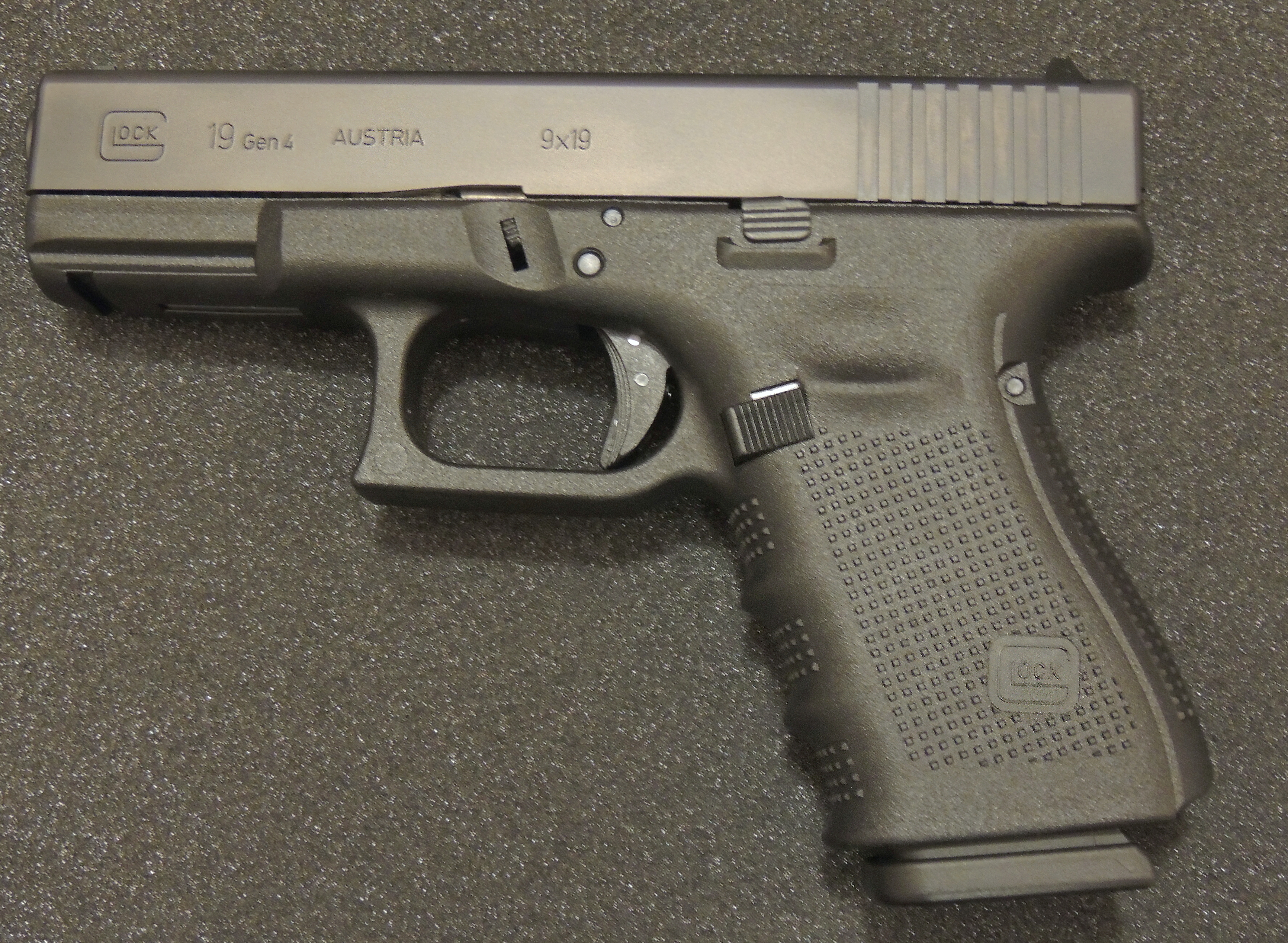 A Glock 19 pistol — an example of the 'firearm or imitation firearm' that, if carried at the critical moment of a burglary, elevates the offence to aggravated burglary under s 10(1).