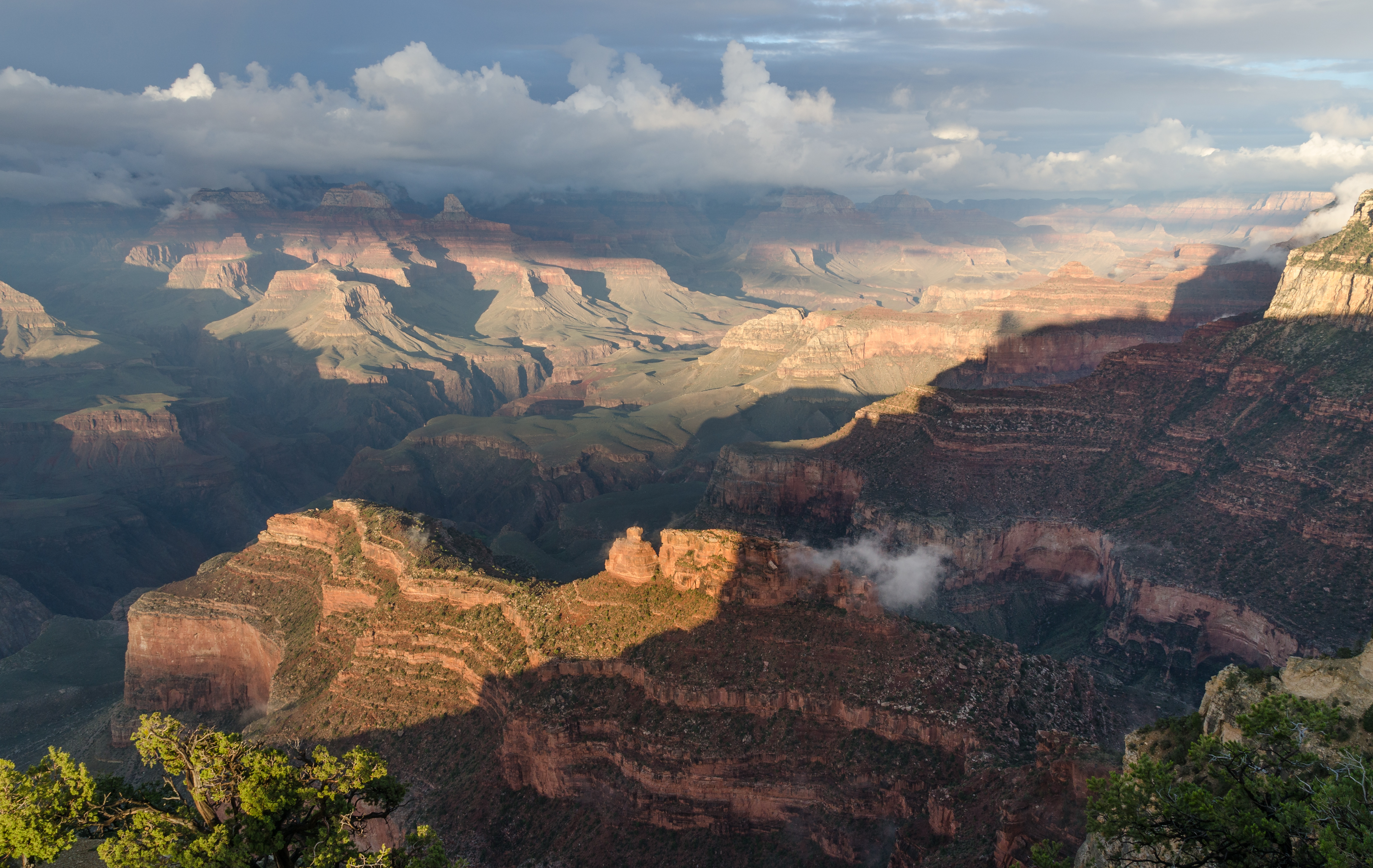 Over millions of years, the continuous flow of river water can erode the underlying geosphere to carve massive V-shaped canyons.