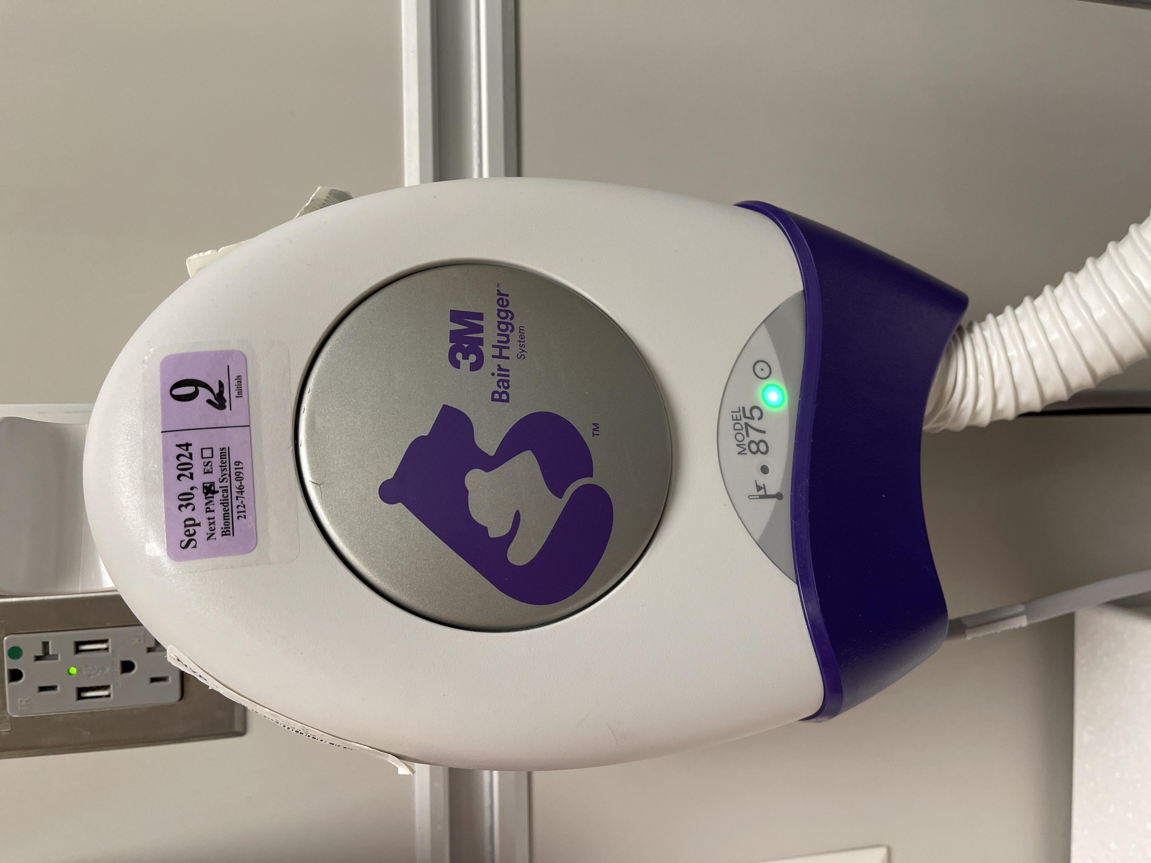 A forced-air warming unit used intraoperatively to actively counteract the rapid heat loss caused by an infant's large body surface area-to-mass ratio.