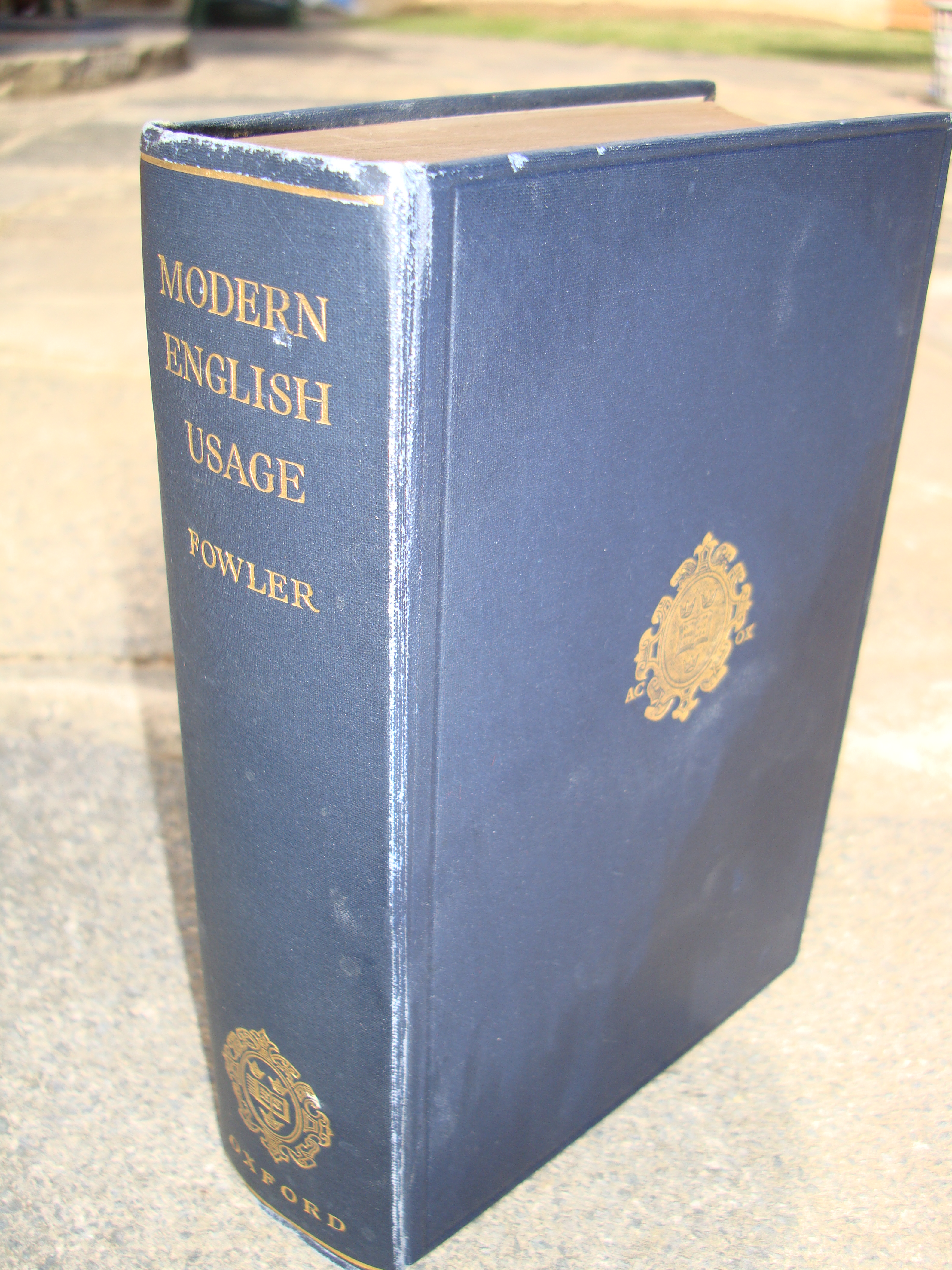 The cover of Fowler's Dictionary of Modern English Usage, a benchmark text for arbitrating prescriptive grammar and style disputes.