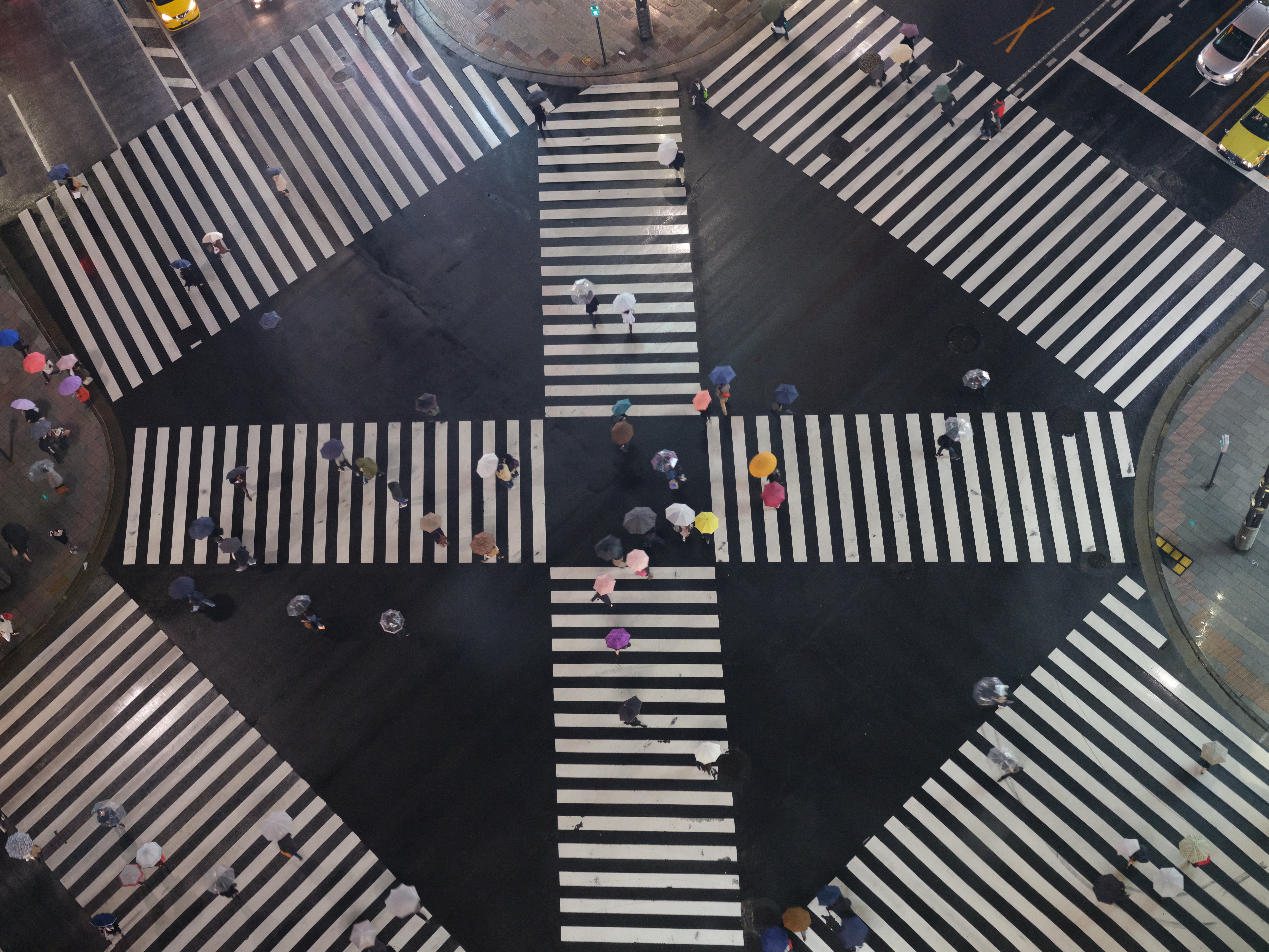 A pedestrian scramble intersection illustrates the complex web of simultaneous cognitive and physical demands required to safely navigate daily community environments.