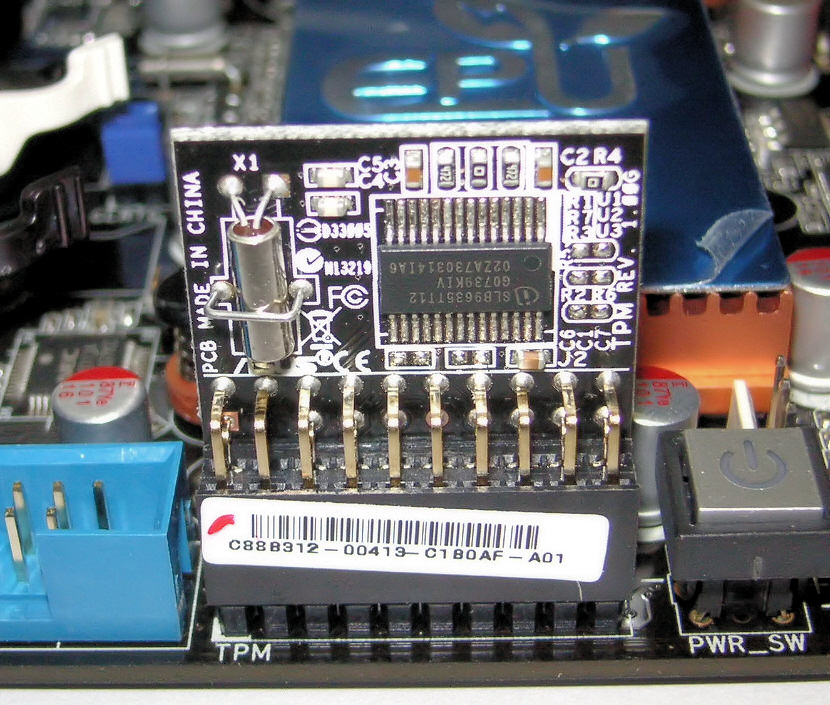 A Trusted Platform Module (TPM) chip physically soldered onto a computer motherboard. This hardware isolation protects cryptographic keys from software-based extraction attempts.