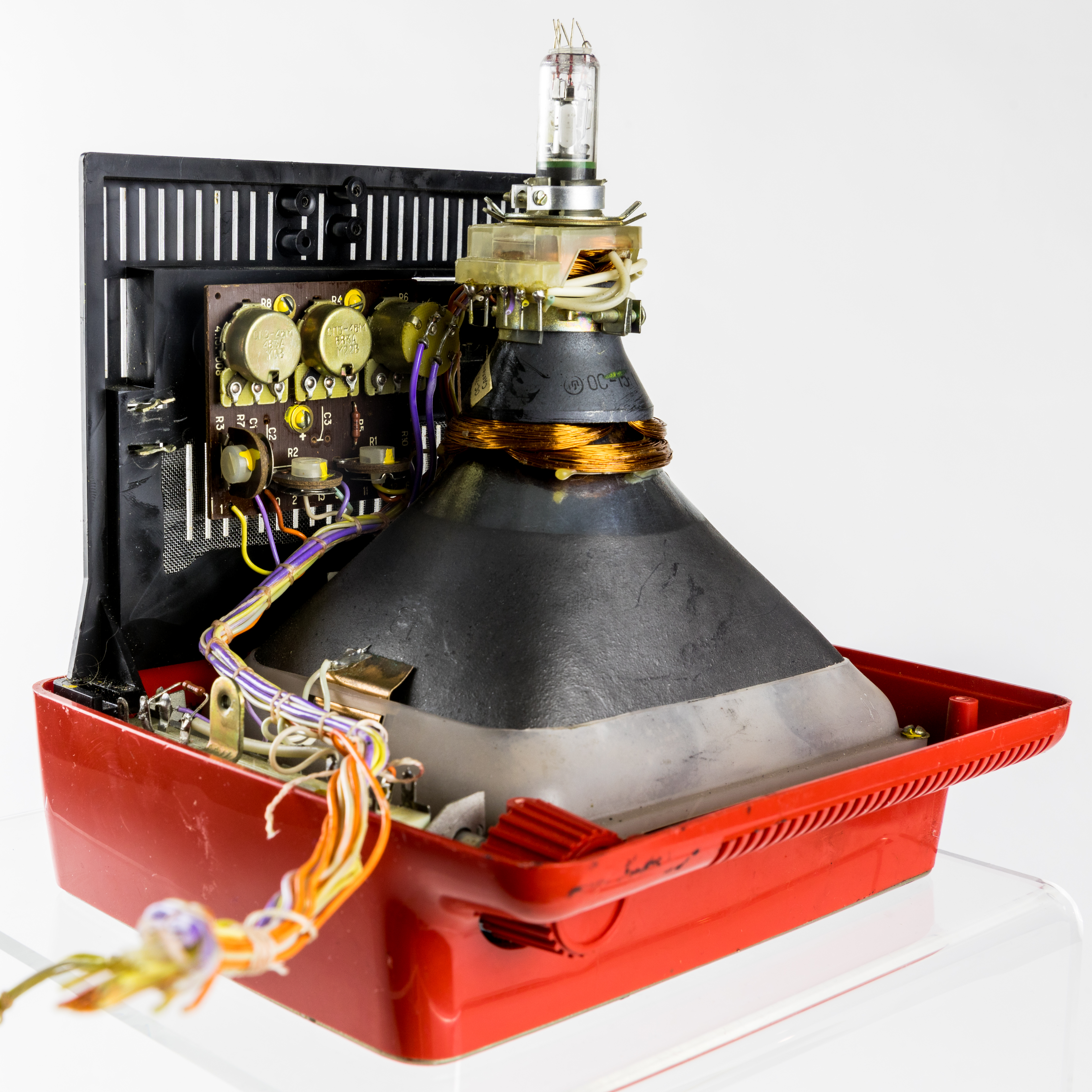 The heavy glass vacuum tube inside a CRT monitor. These legacy displays are highly hazardous to dispose of due to the large amounts of toxic heavy metals, such as lead and barium, used in their construction.