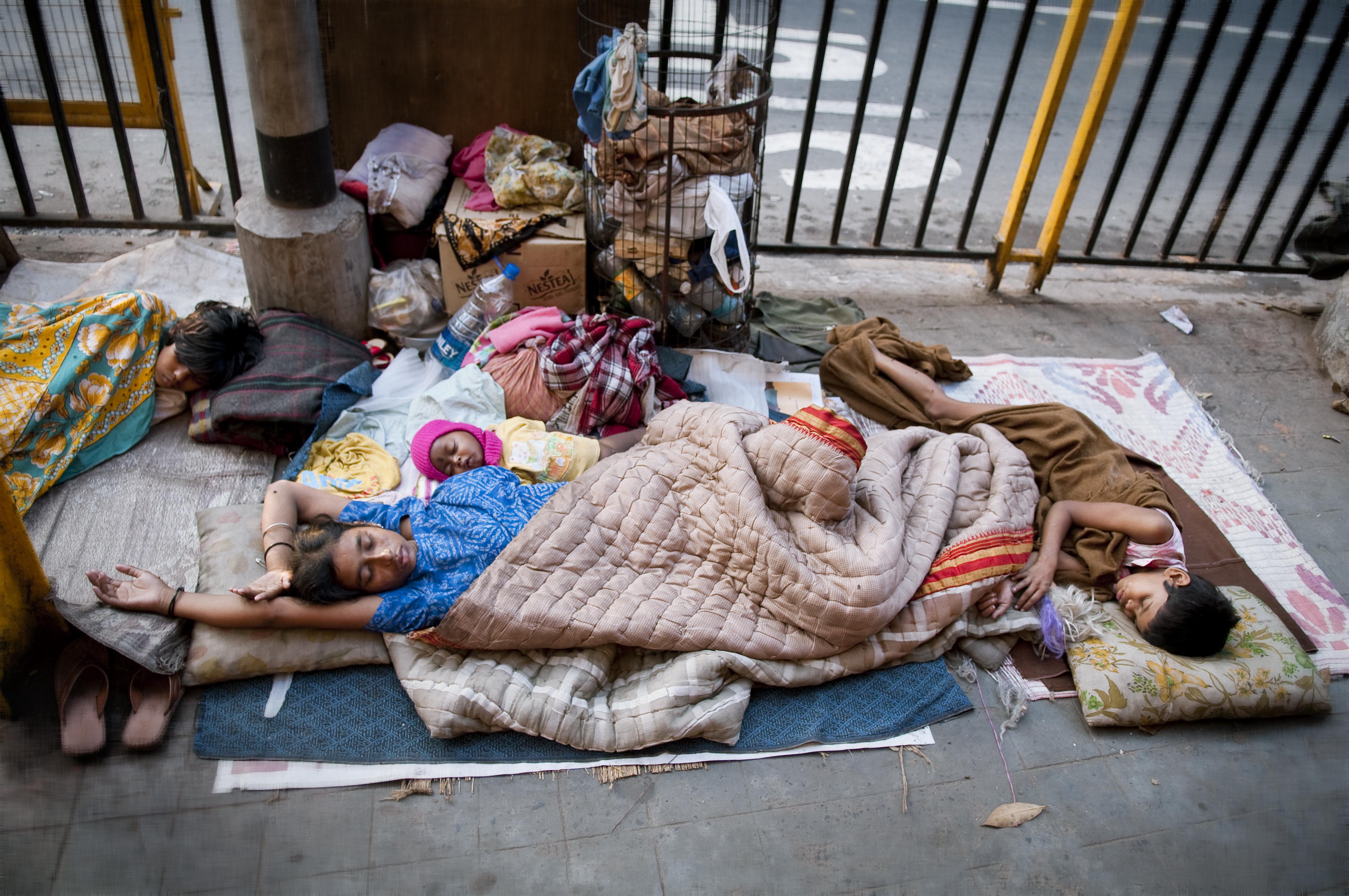 A homeless family in Kolkata — the kind of hardship that 'relief of poverty' charitable trusts, including the narrowly-defined 'poor relations' carve-out, are designed to address.