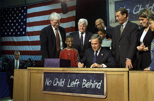 President George W. Bush signing the No Child Left Behind Act in 2002. NCLB shifted special education policy by mandating that students with disabilities be included in state standardized assessments to ensure academic accountability.