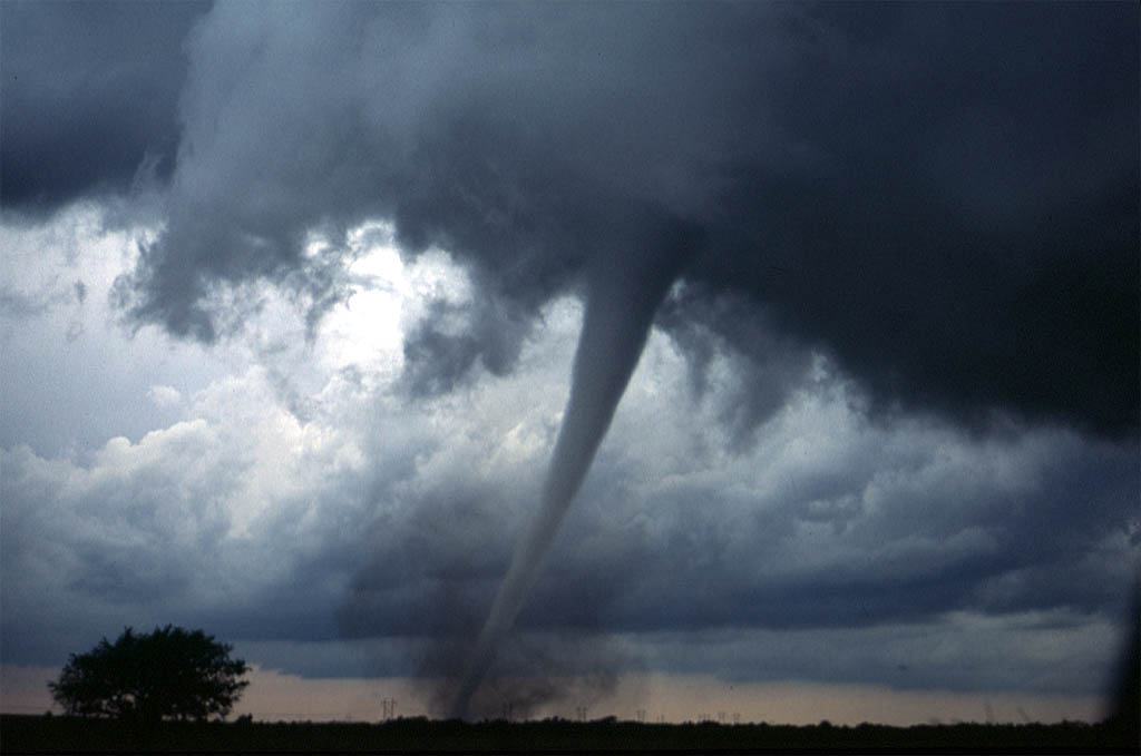 A tornado is a violently rotating column of air extending from a thunderstorm. It is critical for students to distinguish this meteorological cause from its destructive impact on human infrastructure.