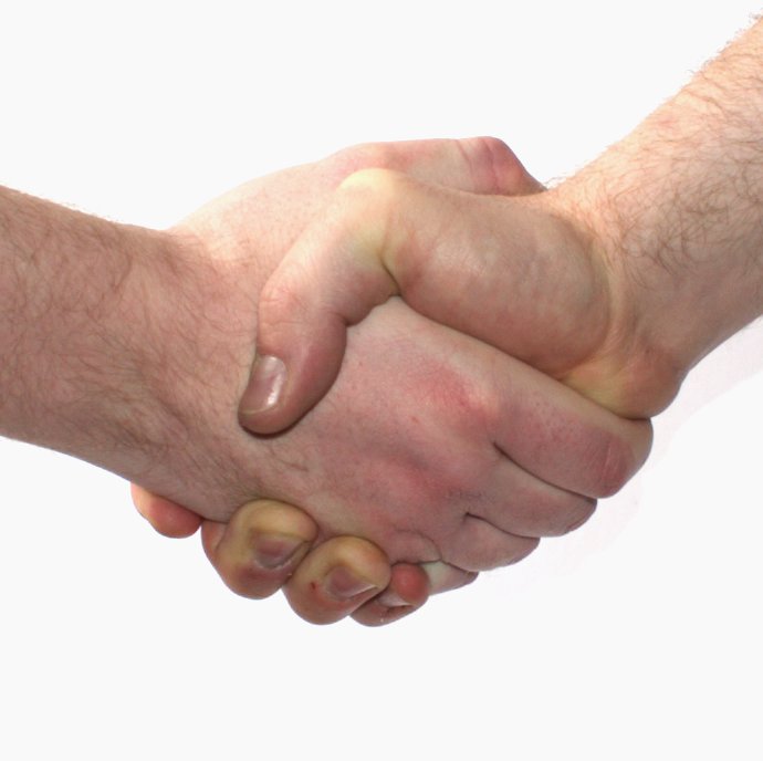 A handshake sealing a business deal — commercial agreements like this are presumed to carry an intention to create legal relations, unlike purely social or domestic arrangements.