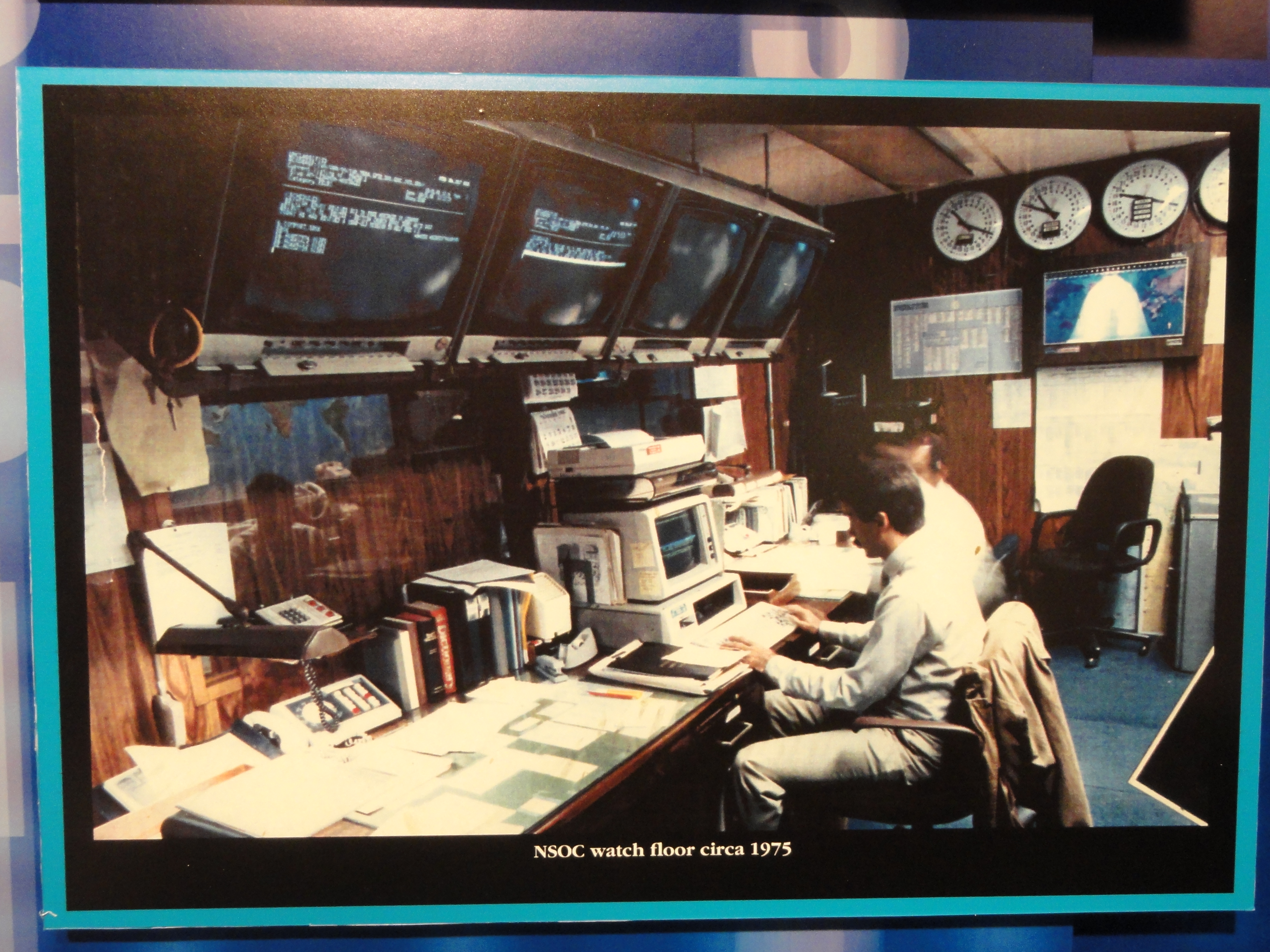 A historical view of the United States National Security Operations Center (c. 1975), illustrating the physical complexity of centralized telemetry and alert monitoring before modern digital architectures.