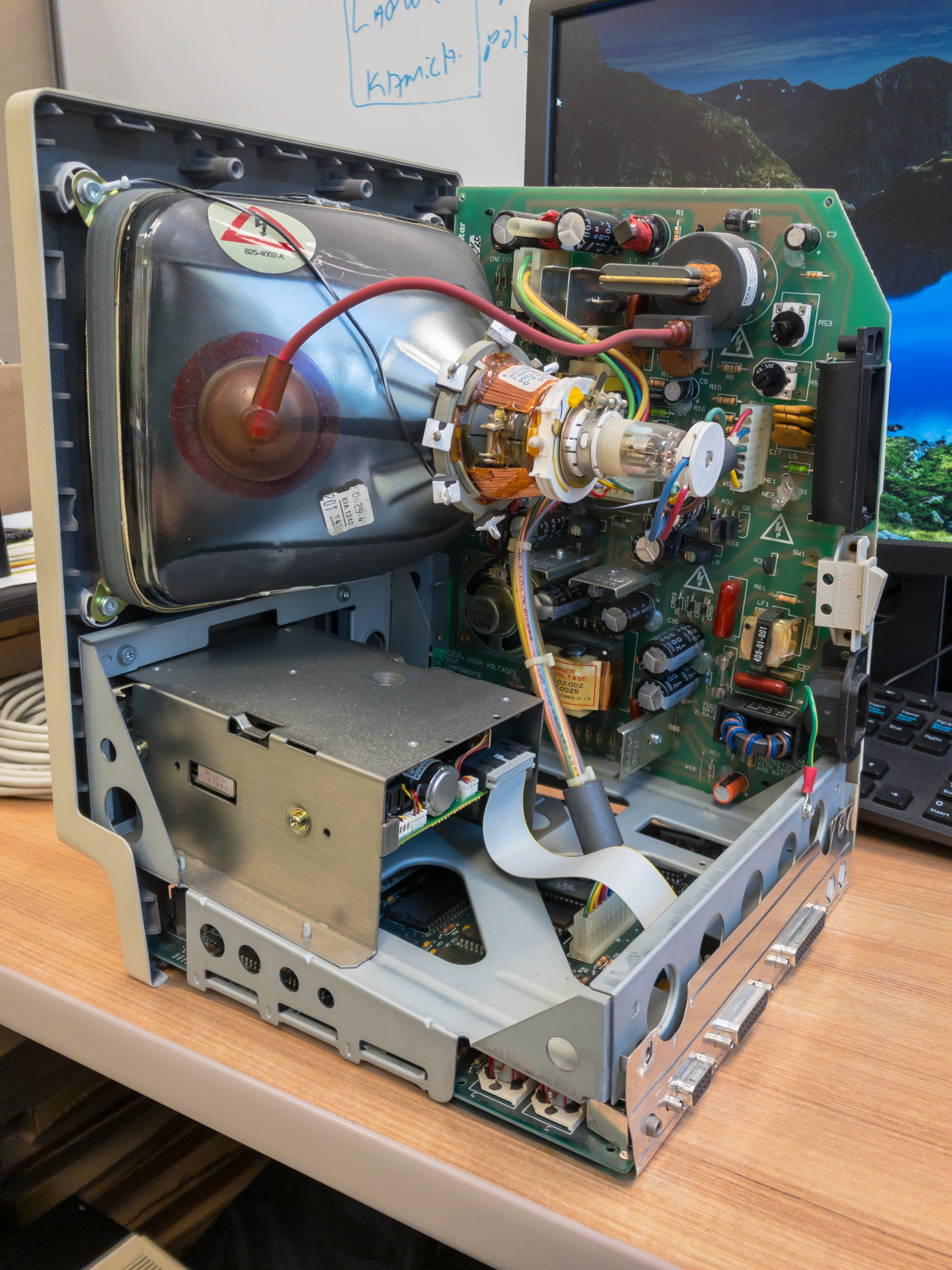 The interior of a legacy Macintosh computer exposing its Cathode Ray Tube (CRT). CRTs contain high-voltage components that present a severe electrocution hazard to untrained technicians, even when unplugged.