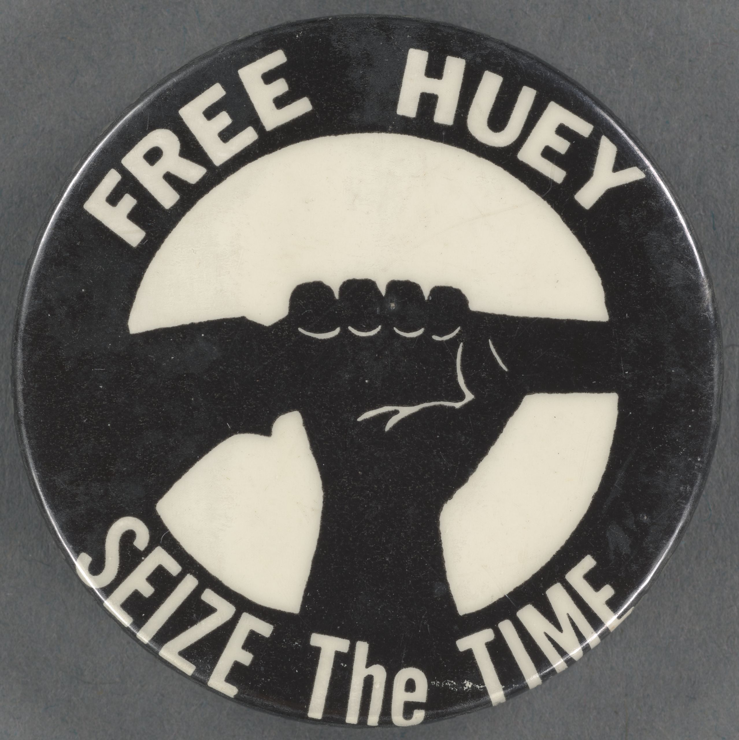A political button demanding the release of Huey P. Newton, reflecting the Black Panther Party's shift toward radical self-defense and community empowerment.