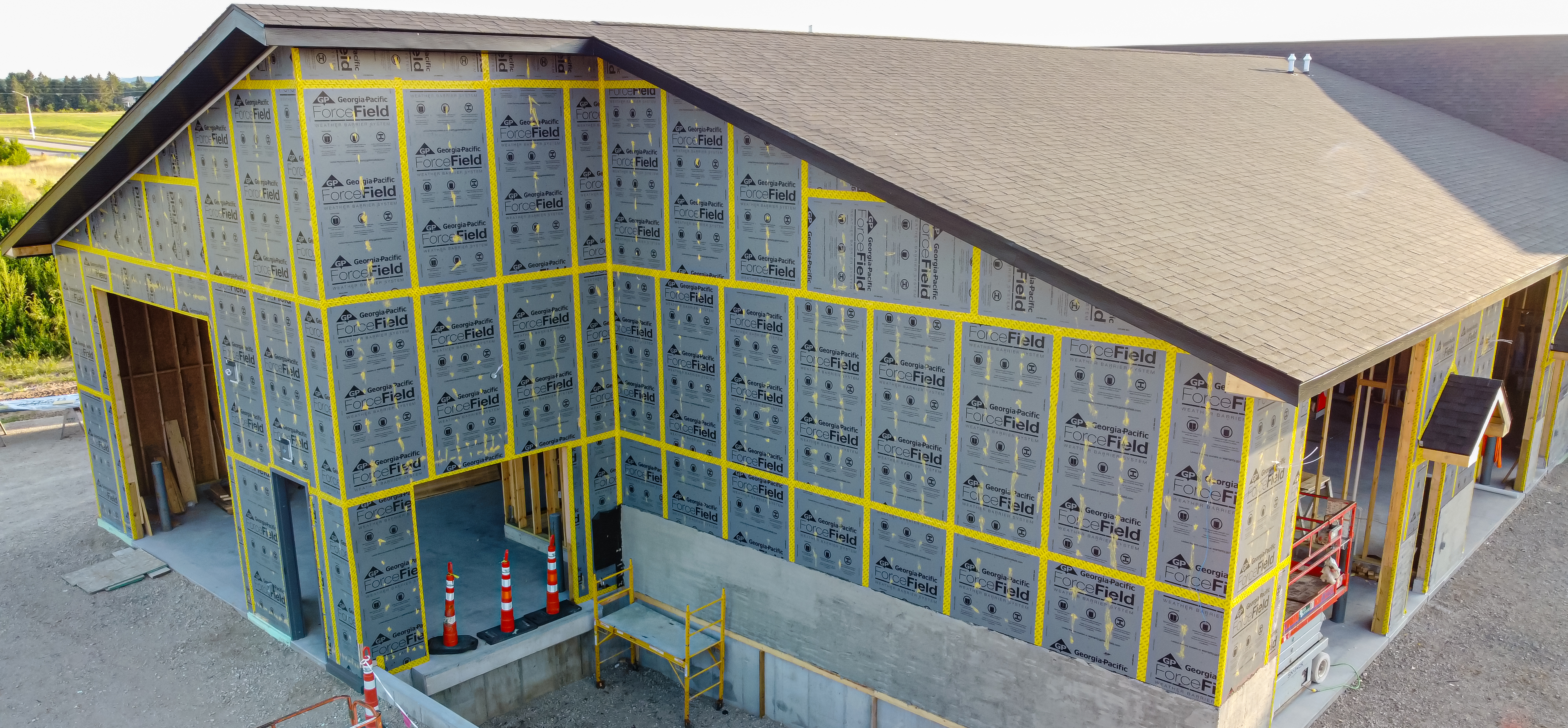 Exterior wall sheathing provides structural rigidity, transforming the vertical studs into a solid, wind-resistant box while adding weather protection.