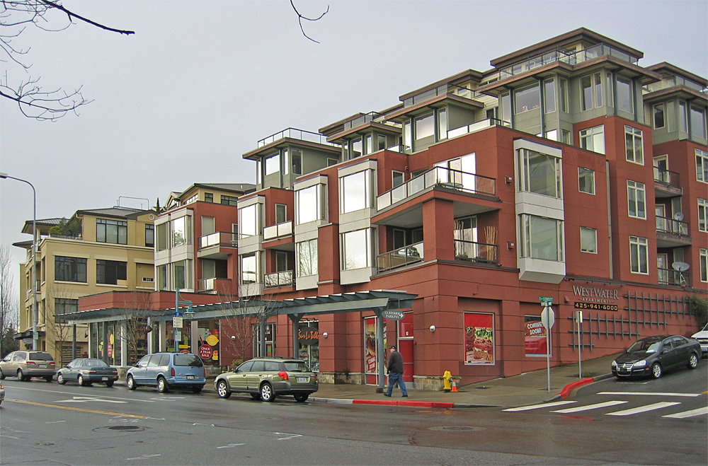 A vertical mixed-use development combining commercial retail spaces and medical offices on the ground floor with residential apartments above.