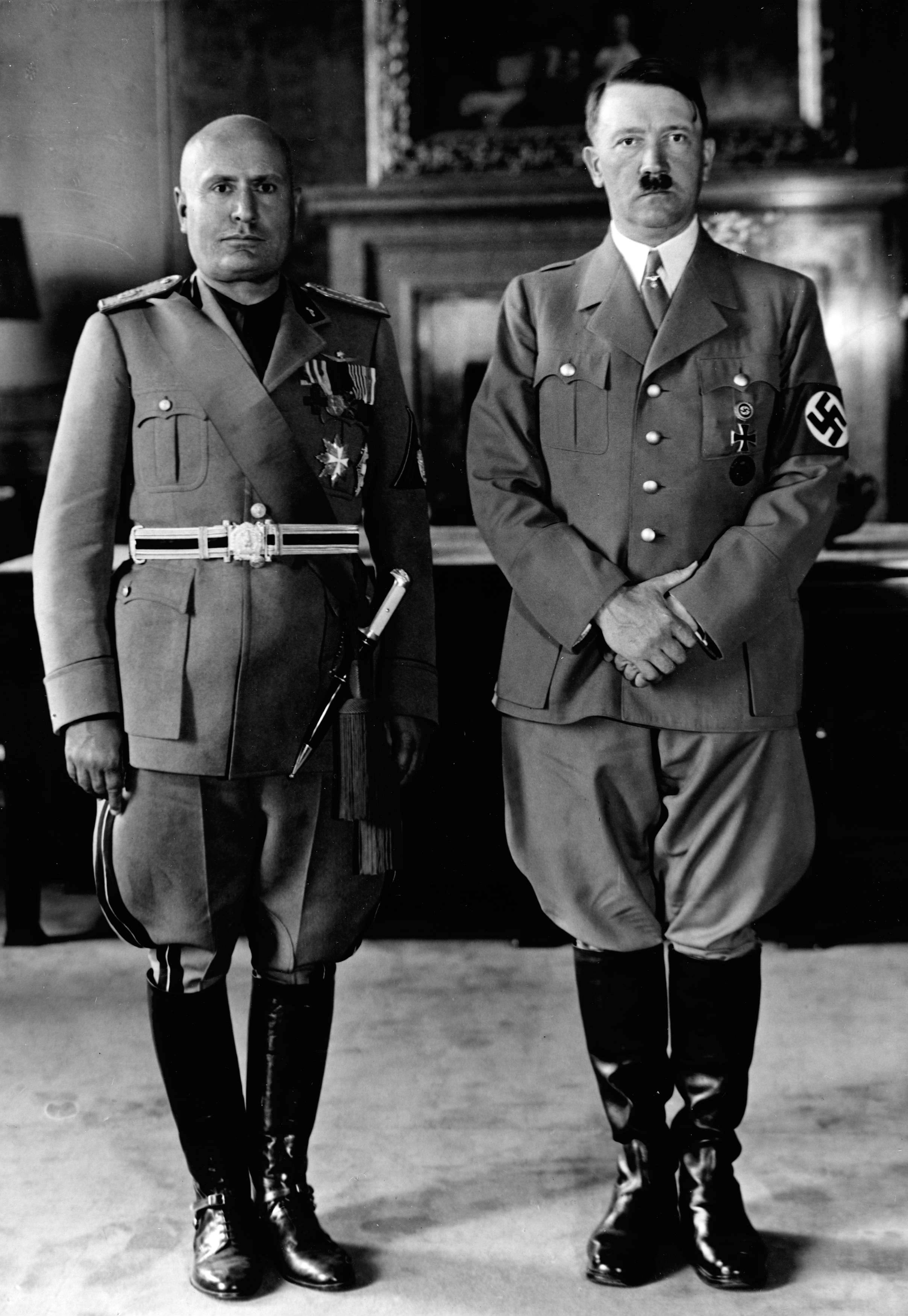 Fascist dictators Adolf Hitler and Benito Mussolini, whose regimes militarized their respective nations and violently suppressed political opposition.