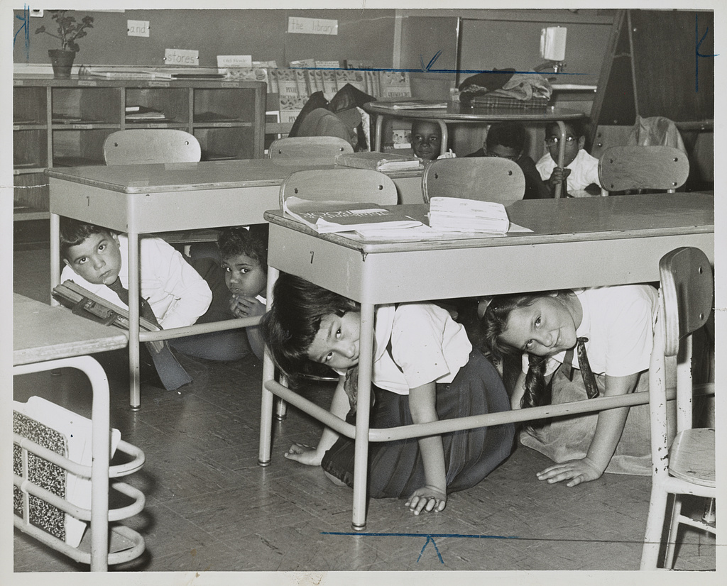 Schoolchildren practicing a "duck and cover" drill in 1962, a civil defense measure to prepare for potential nuclear attacks.