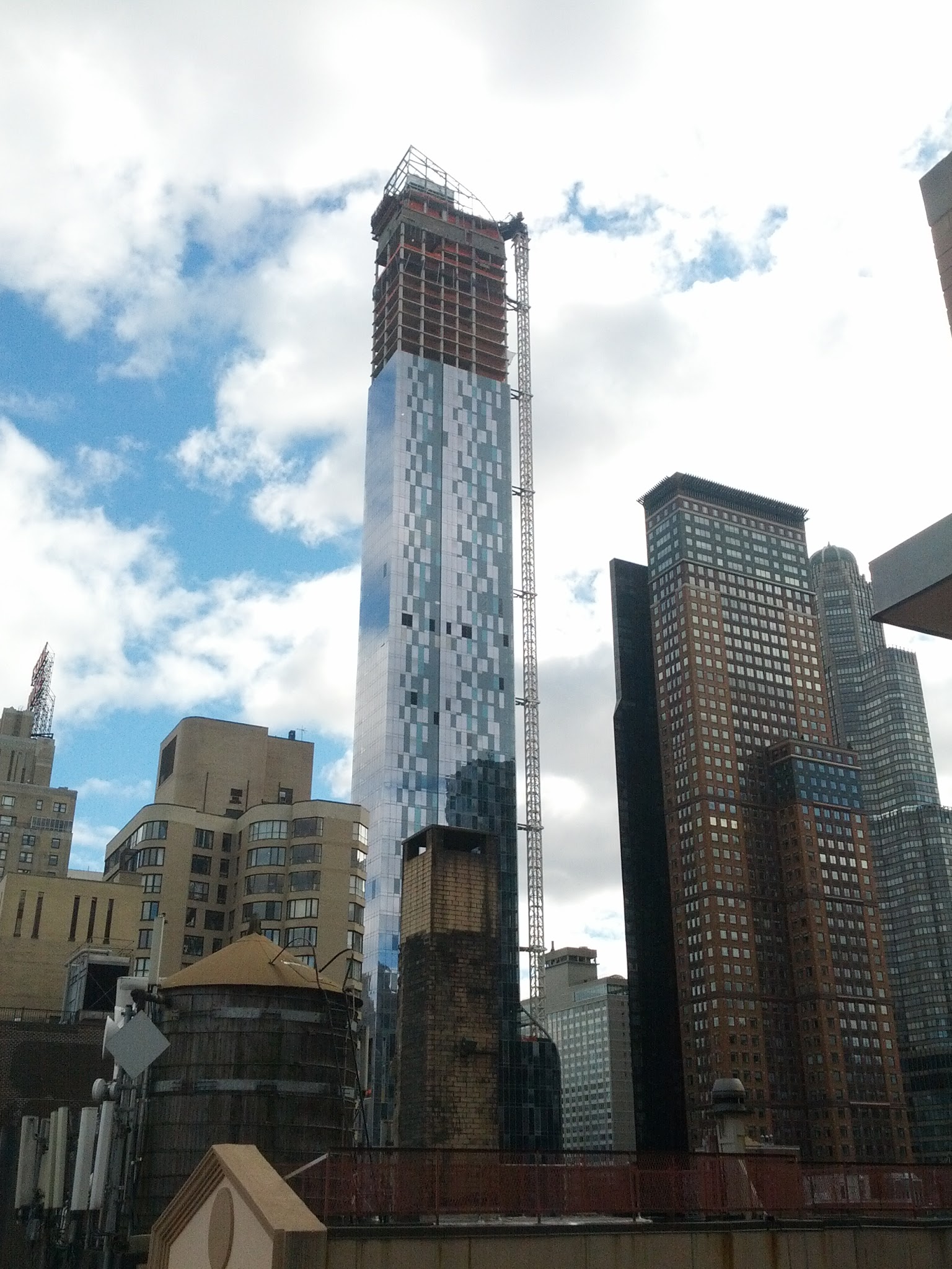 A skyscraper under construction — developments like this must clear planning permission, the kind of condition subsequent that can automatically discharge a contract, such as a lease, if refused.