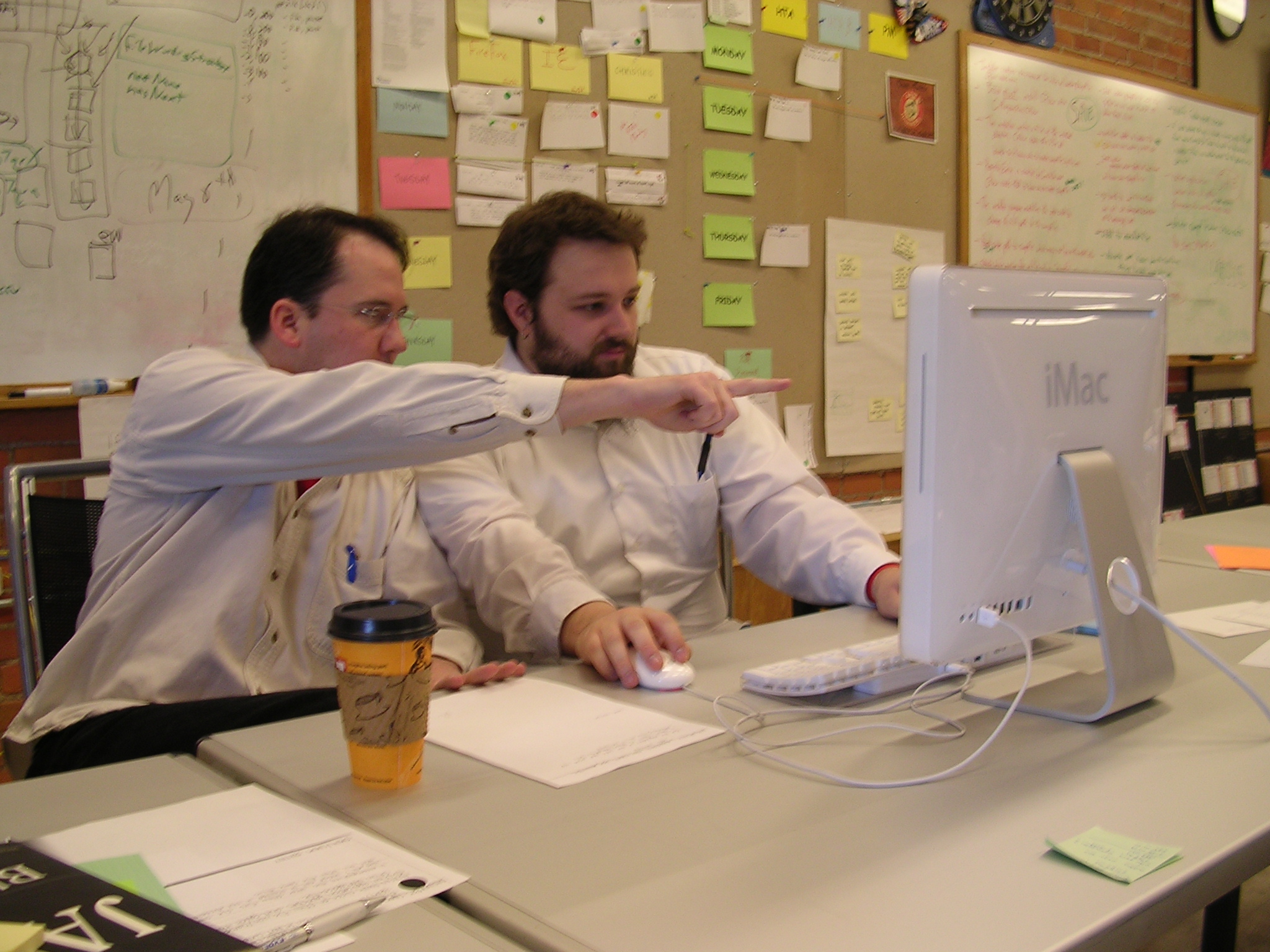 In Extreme Programming, pair programming unites two developers at one workstation to simultaneously write and review code, improving design and reducing defects.
