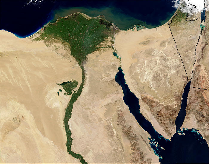 A satellite view of the Nile River Delta at night, vividly illustrating how modern human settlement patterns remain densely clustered around historic freshwater sources.