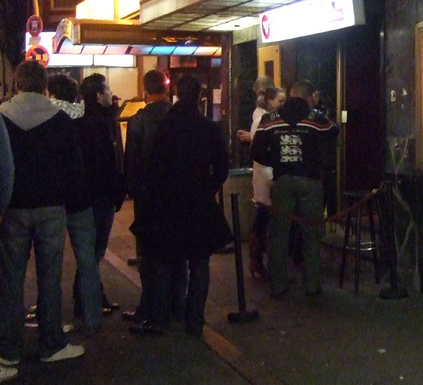Door staff enforcing a nightclub's closing time — a patron who refuses to leave illustrates the temporal limit on visitor permission.
