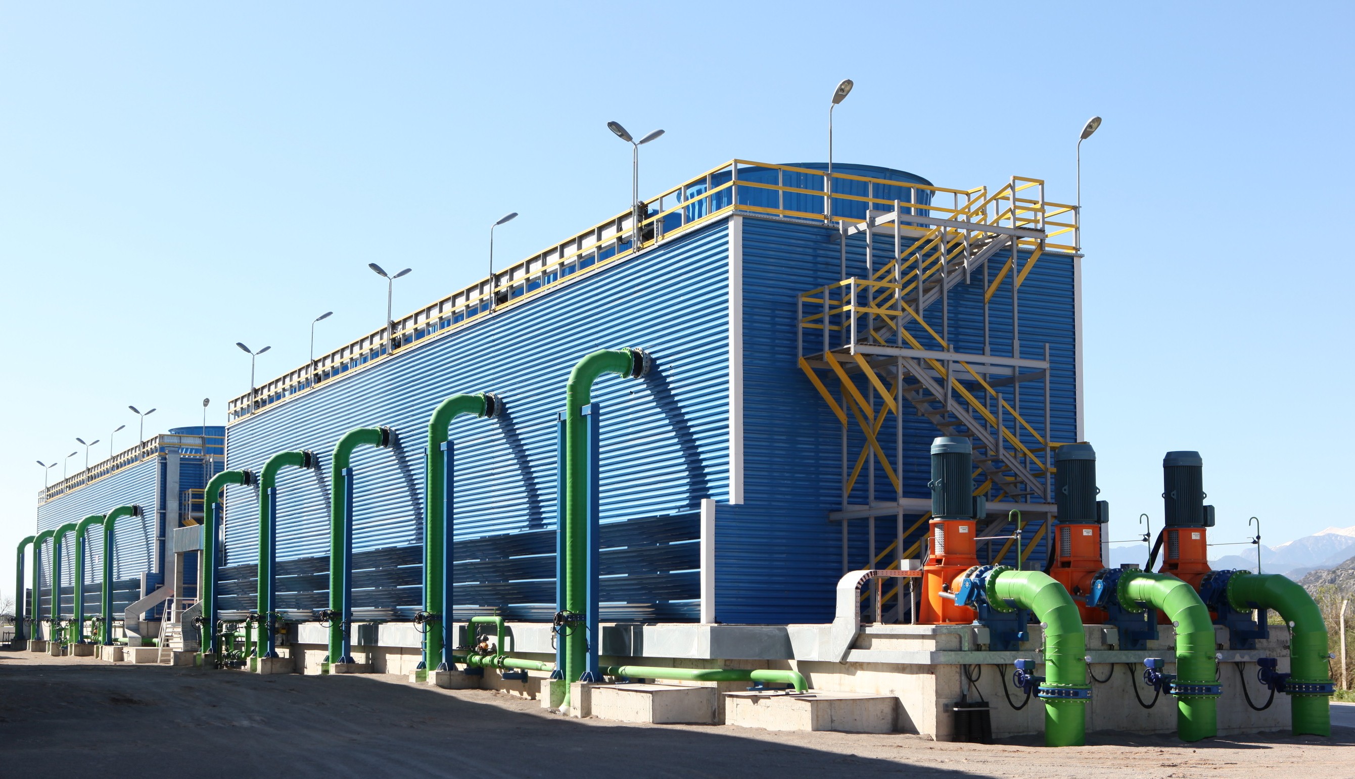 Industrial-scale cooling towers are required to dissipate the massive amounts of heat generated by tens of thousands of continuously running computer servers inside a datacenter facility.