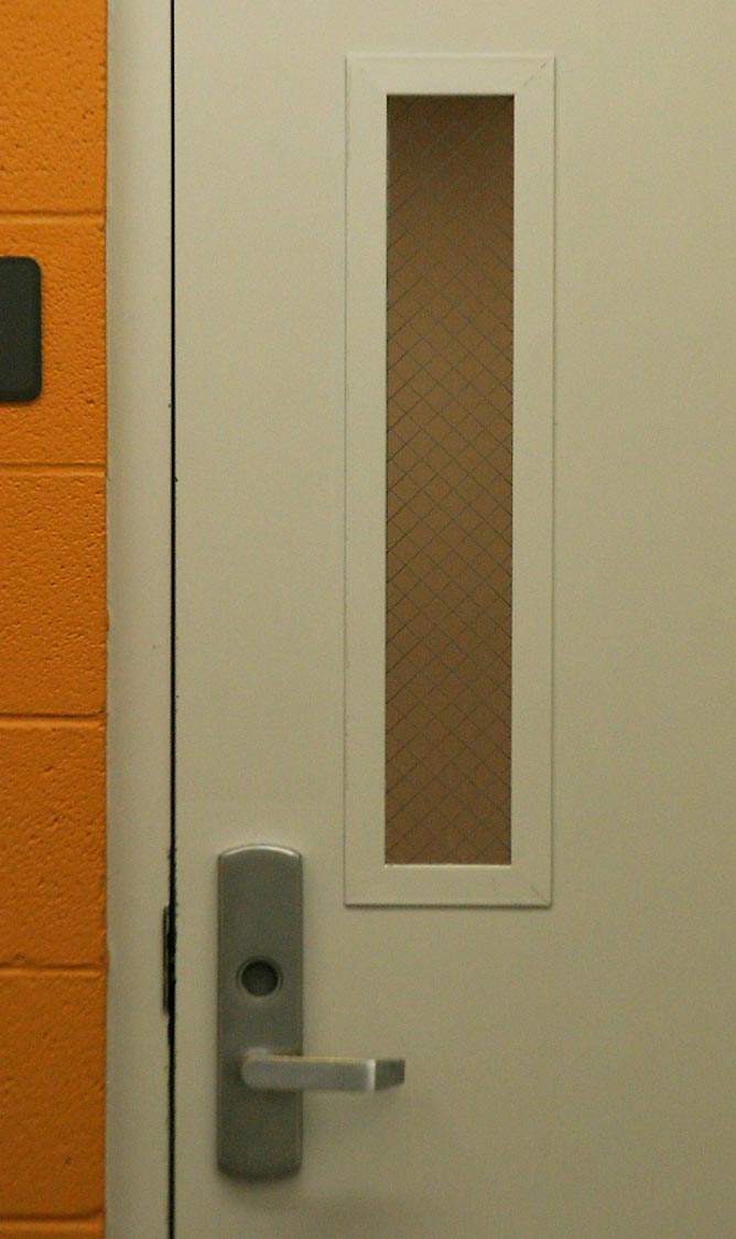 Heavy fire doors compartmentalize a hospital structure, allowing staff to perform horizontal evacuations by moving patients into adjacent safe zones on the same floor.