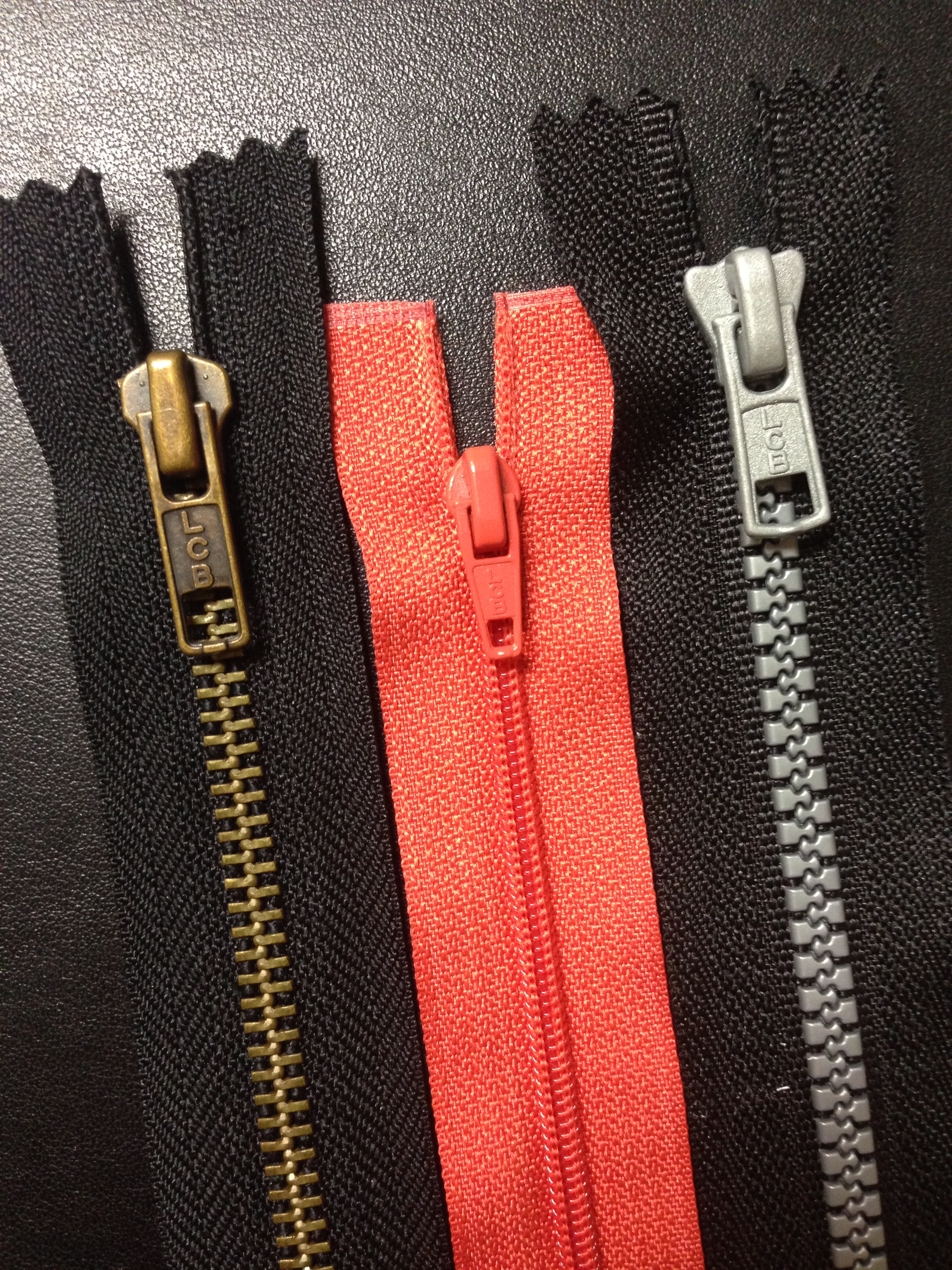Material generalization requires a student to transfer skills learned on instructional materials, such as large plastic zippers, to real-world variations like smaller coil and metal zippers.