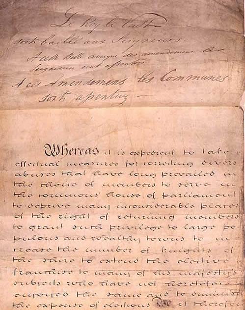 The parchment roll of an Act of Parliament recording the monarch's royal assent — the same formal step the Human Rights Act 1998 received on 9 November 1998.