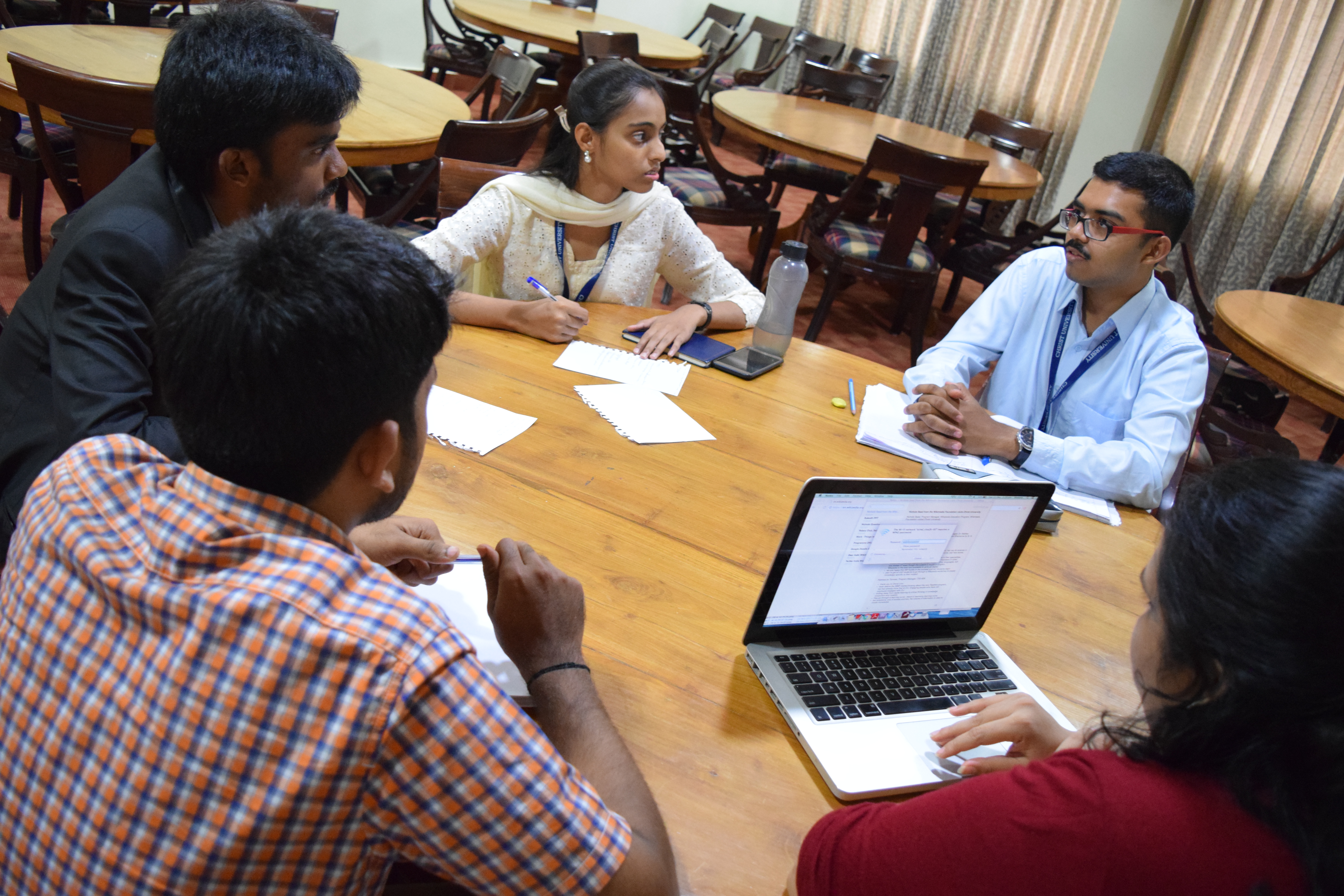 In a focus group, a trained moderator guides an interactive discussion to uncover the qualitative reasons behind stakeholder attitudes.