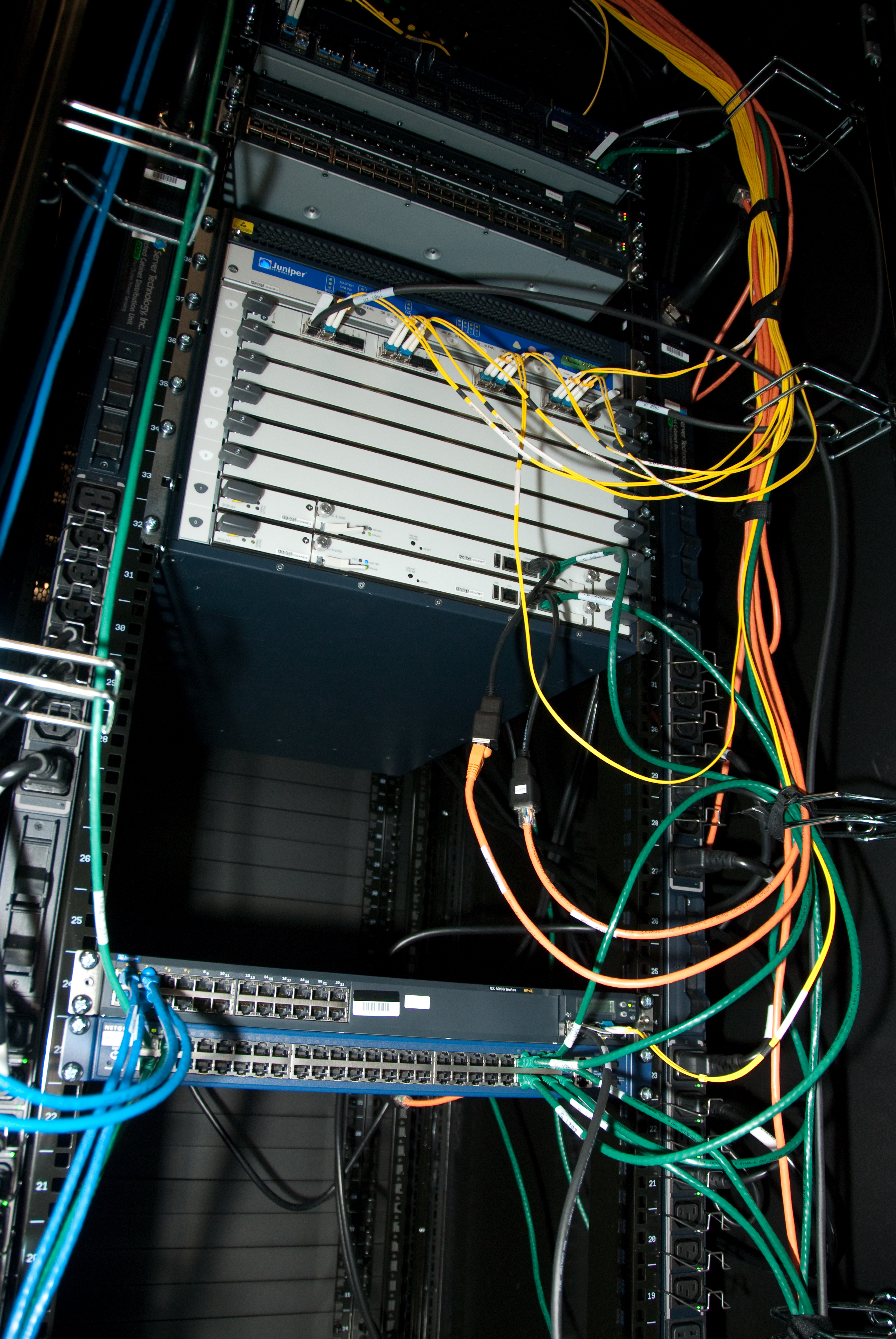 A modern data center relies on dense physical infrastructure, servers, and cabling to host and execute virtualized network functions.