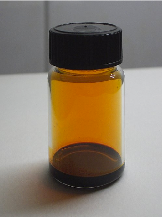 Liquid bromine in a vial, demonstrating high volatility as it vaporizes at room temperature. Textual clues about handling such hazardous materials allow readers to logically predict future accidents.