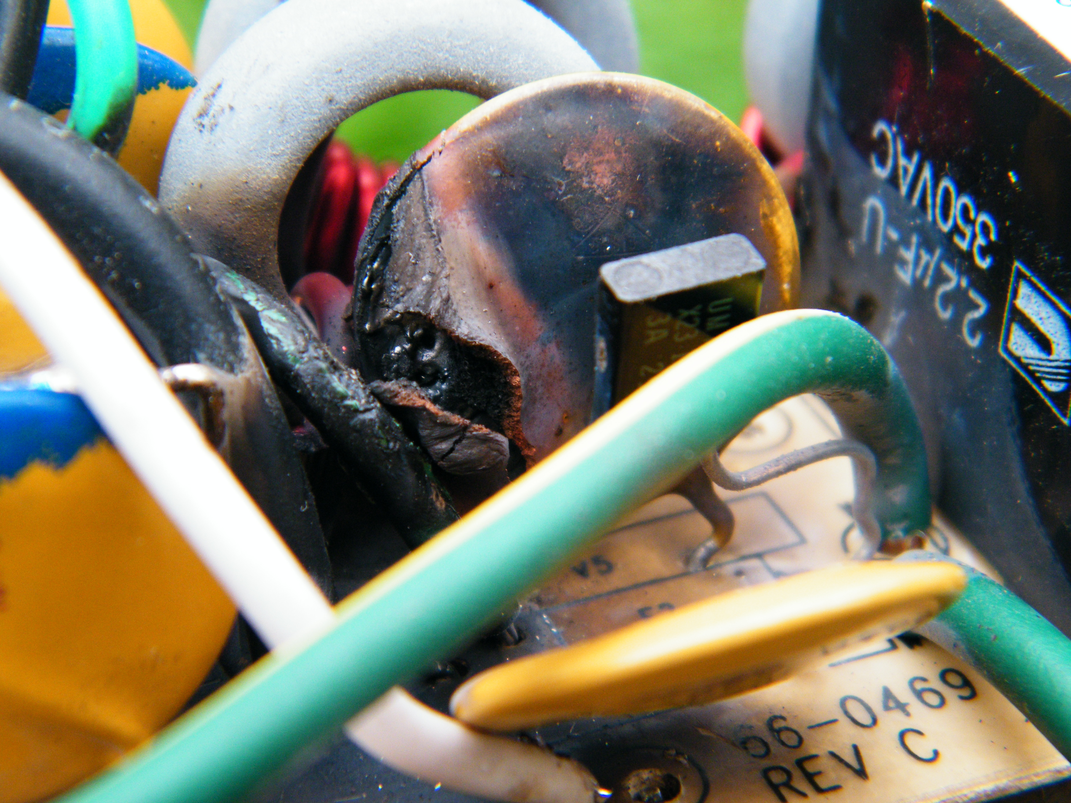 A blown internal component inside a consumer surge protector. Once a surge suppressor absorbs voltage spikes exceeding its maximum Joule rating, its sacrificial components fail and the device no longer protects connected hardware.
