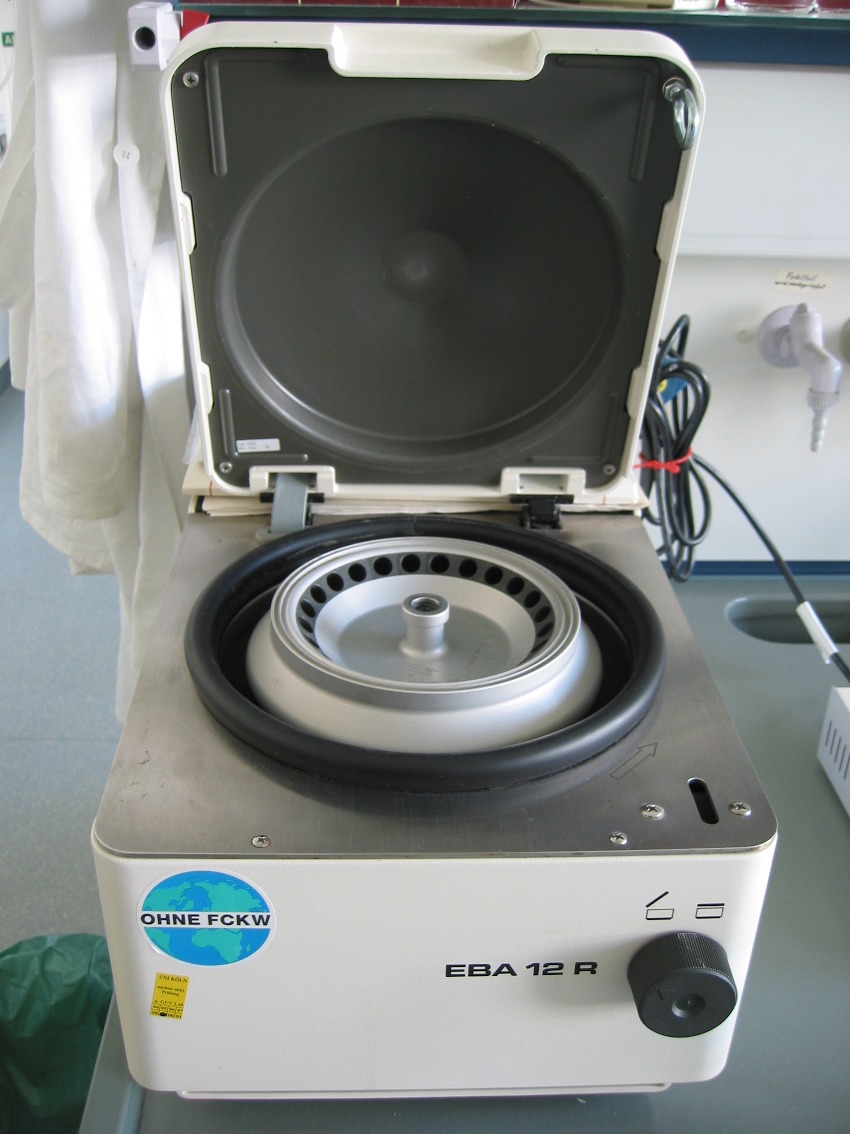 A laboratory centrifuge relies on balanced mass distribution; an unbalanced rotor spinning at high RPMs can vibrate violently and cause catastrophic mechanical failure.