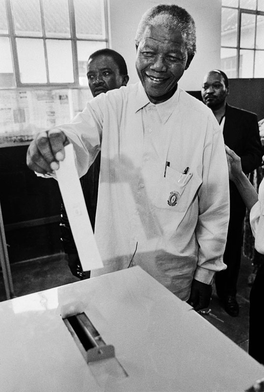 Nelson Mandela casting his ballot in 1994 during South Africa's first multiracial democratic election, officially marking the end of the Apartheid system.