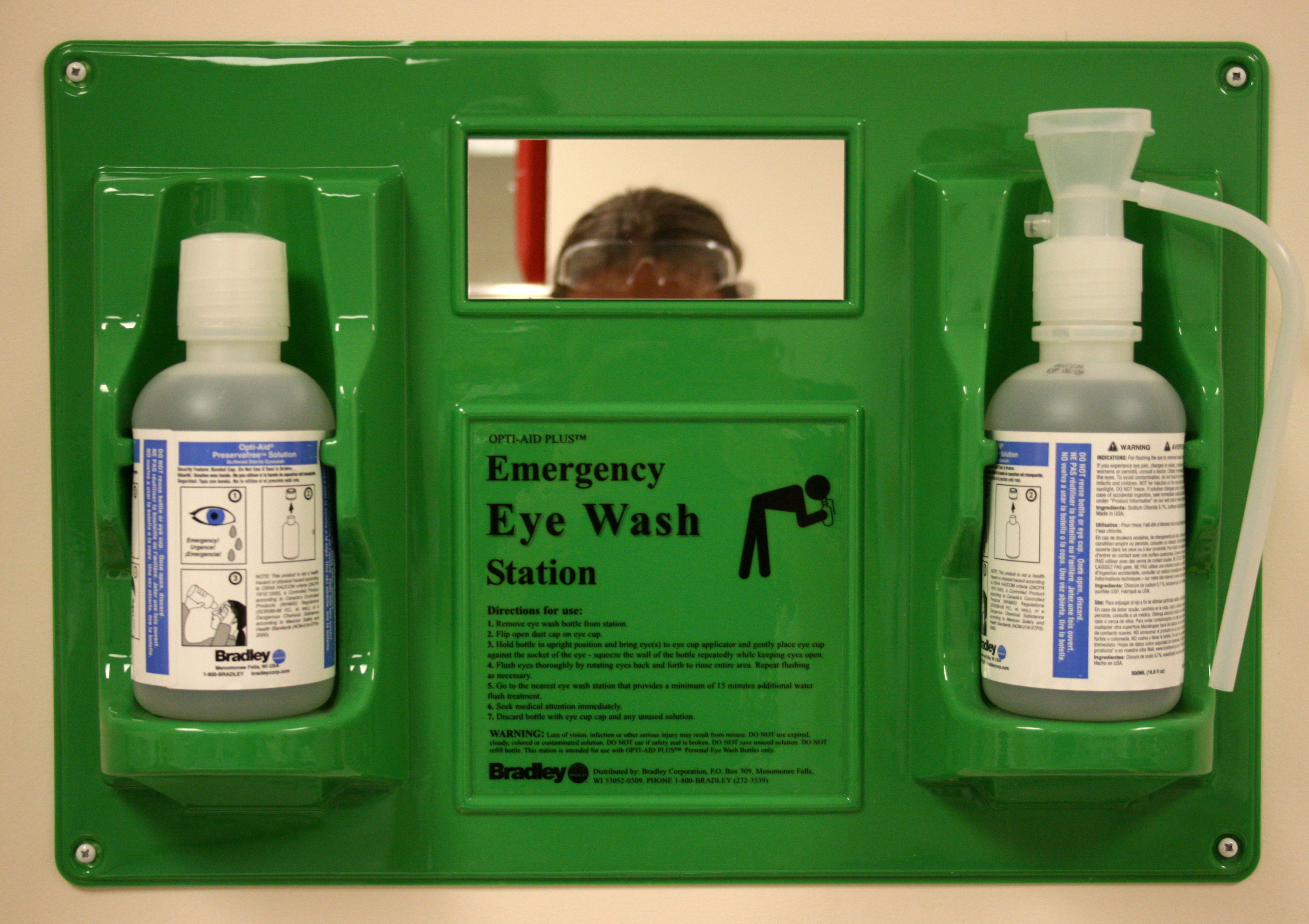 An emergency eyewash station must be capable of delivering a continuous stream of water for at least fifteen minutes to effectively flush hazardous chemicals from the eyes.