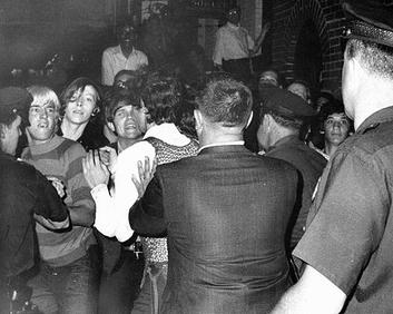 A front-page photo of the 1969 Stonewall riots, marking the moment when marginalized LGBTQ patrons physically fought back against police raids, igniting the modern gay rights movement.
