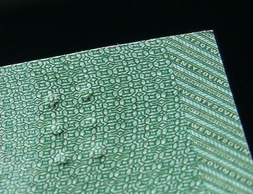 Tactile features, such as those embedded in this banknote, represent the types of environmental and educational adaptations necessary for students with blindness who must bypass the visual channel and rely on touch to process information.