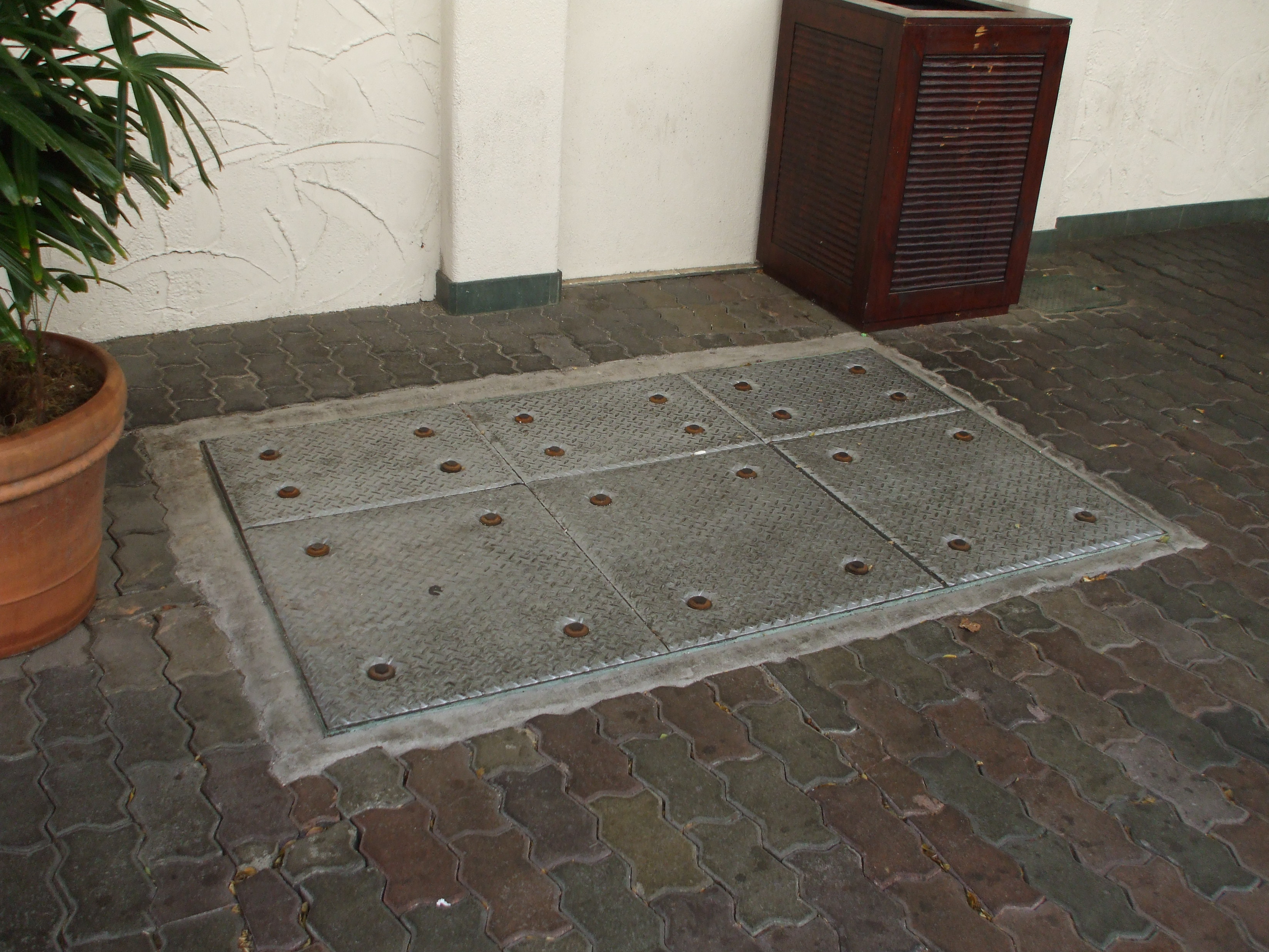 An external, in-ground grease trap for a commercial restaurant. Health departments strictly regulate these systems to prevent fats and oils from causing blockages and sanitary backups in municipal sewers.