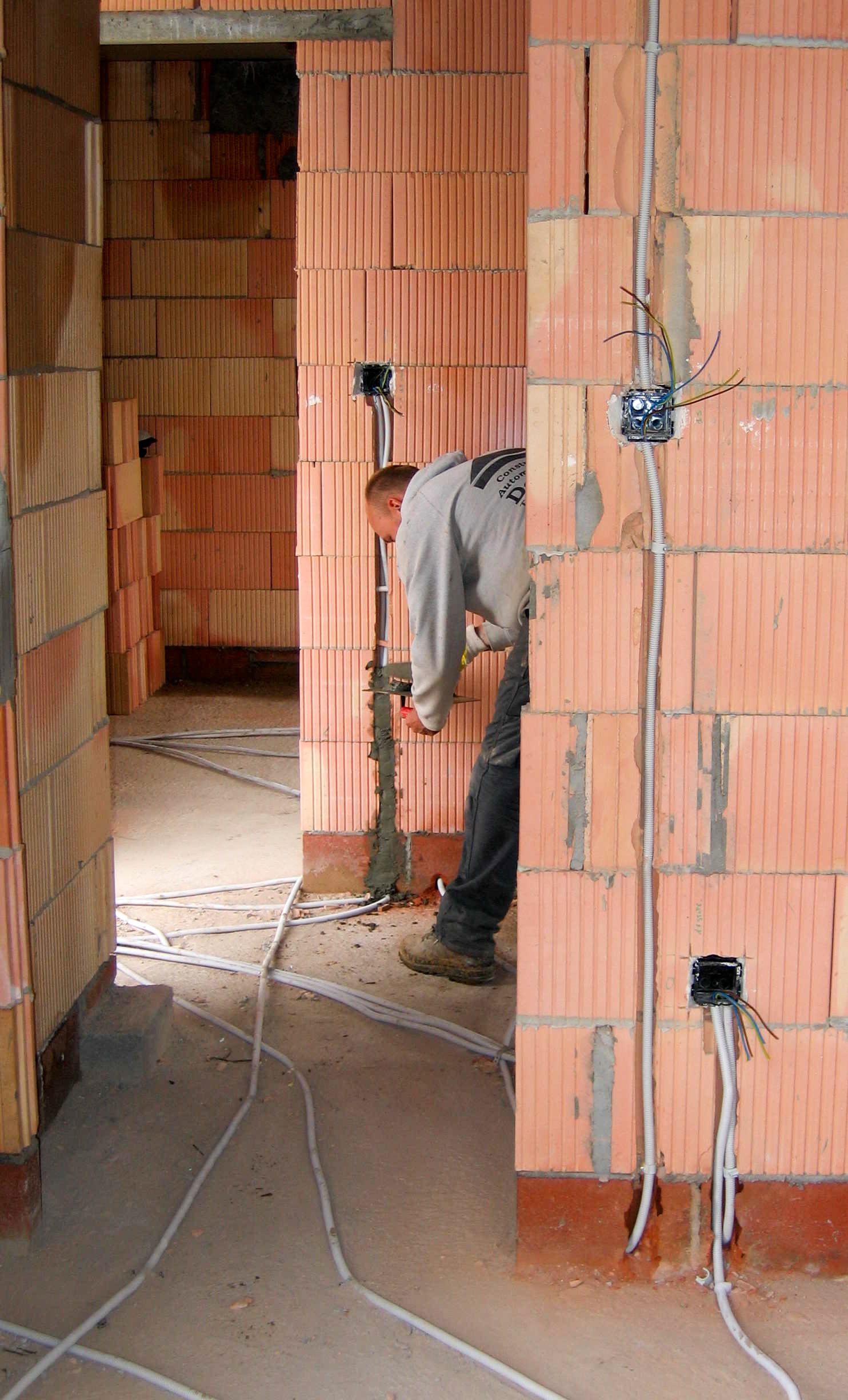 An electrical "rough-in" phase before drywall is installed. Building inspectors review this exposed wiring to verify fire and safety code compliance before construction proceeds.