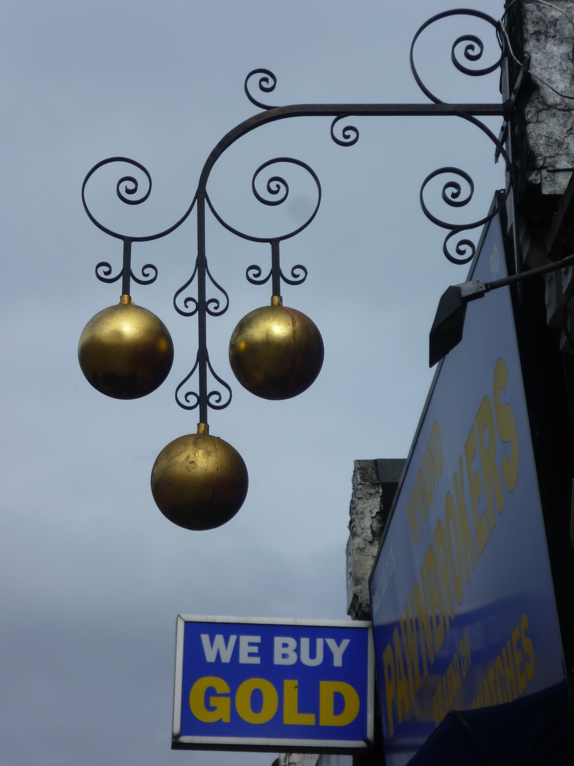 A pawnbroker's sign in London — the everyday example of a pledge, where possession of goods is handed to the creditor as security until the debt is repaid.