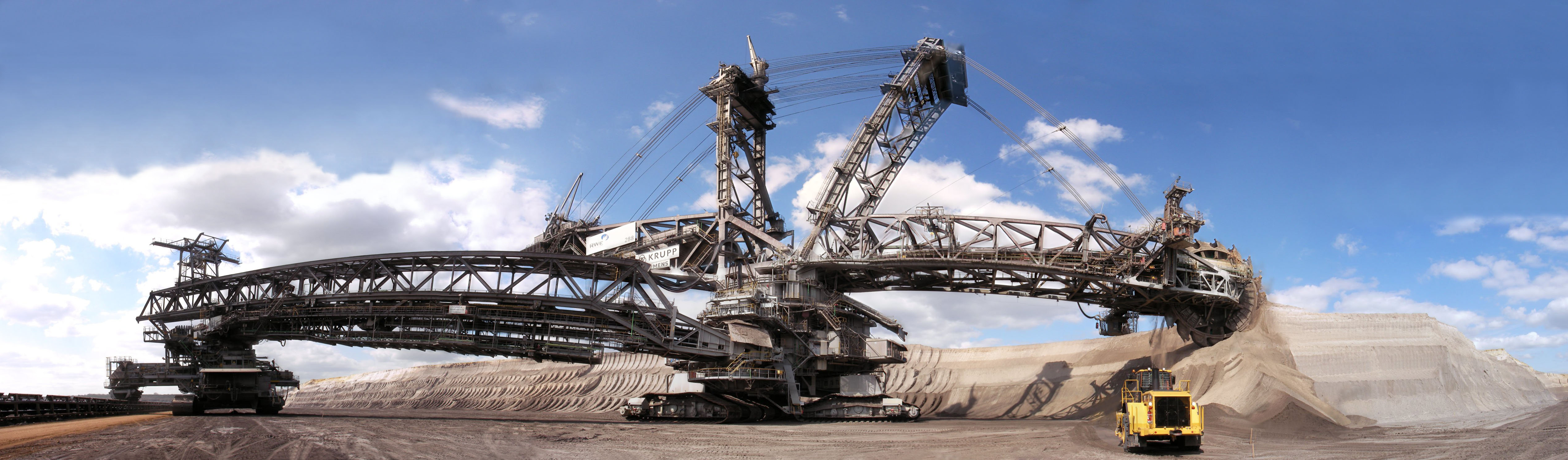 Massive bucket-wheel excavators used in surface mining fundamentally alter the topography of the land, permanently reshaping the Earth's crust and displacing local ecosystems.