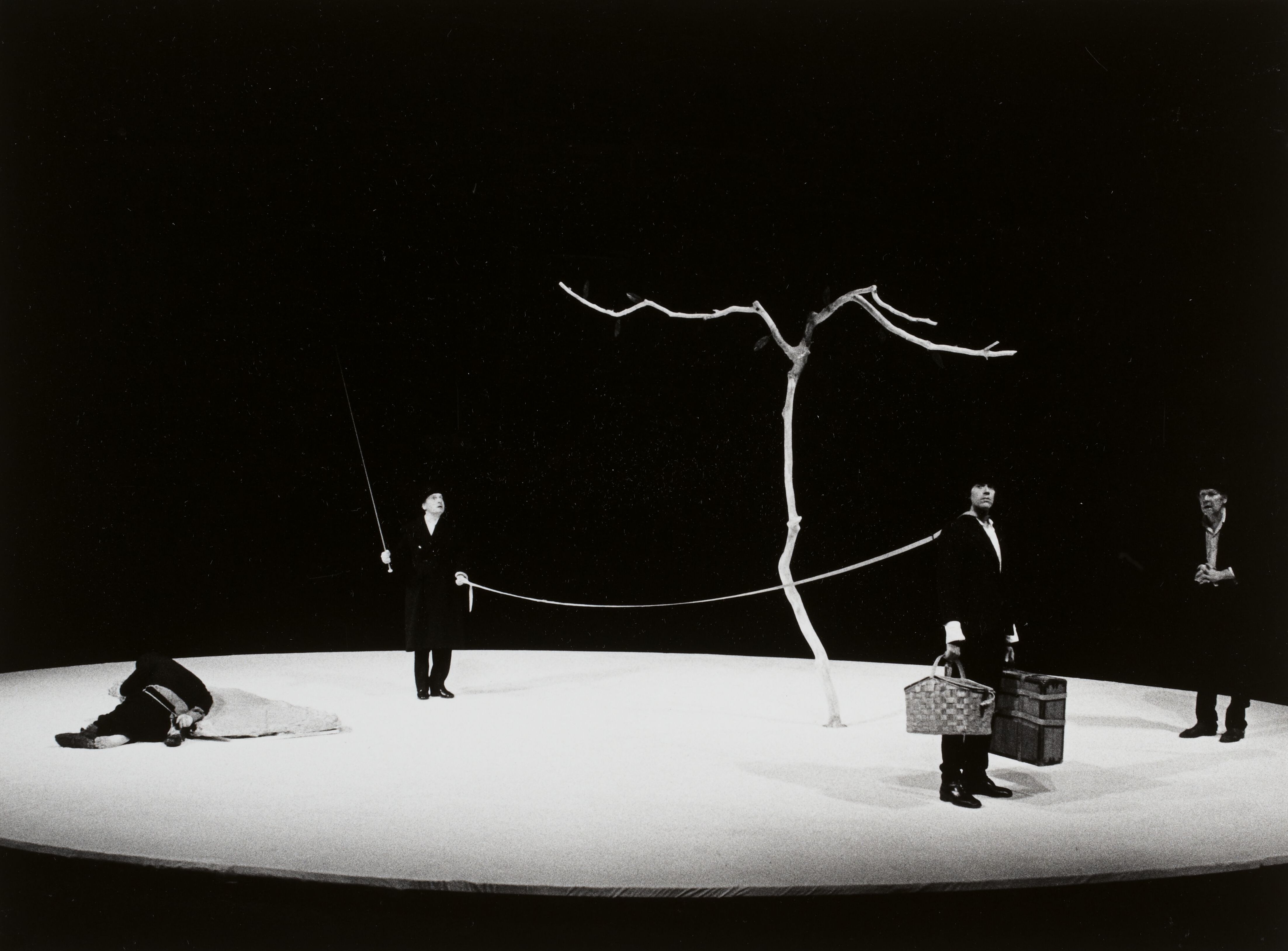 A minimalist stage setup for a 1978 production of "Waiting for Godot." The barren environment reflects the Theatre of the Absurd's focus on existential emptiness.