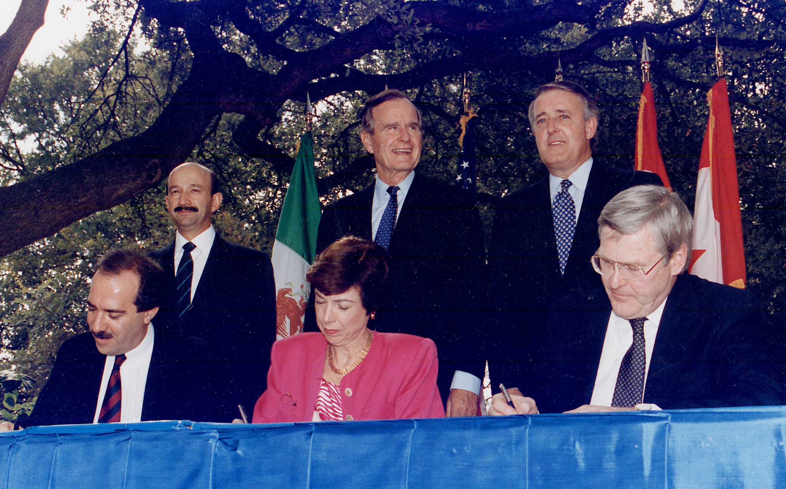 Leaders of Mexico, the United States, and Canada initialing the draft North American Free Trade Agreement (NAFTA) in 1992, an example of a regional free trade agreement designed to eliminate tariffs between member states.