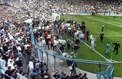 Liverpool fans try to climb the fence to escape the crush at Hillsborough Stadium, 1989 — the disaster that gave rise to Alcock v Chief Constable of South Yorkshire Police and its four control mechanisms for secondary victims.