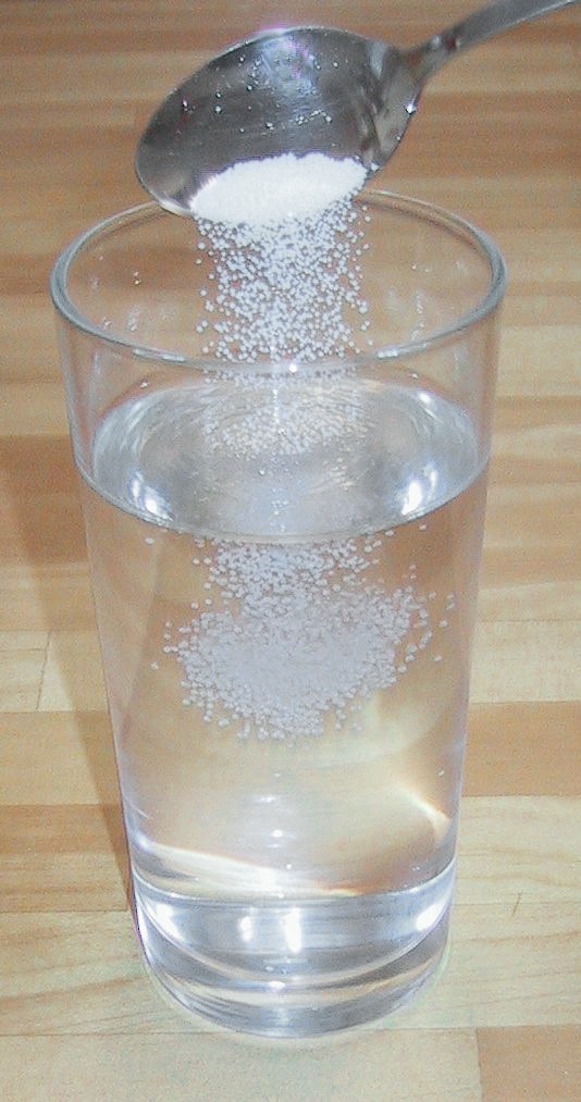Making a homogeneous saline solution by dissolving table salt (the solute) into water (the solvent). Because the salt is evenly distributed, the resulting mixture is perfectly uniform.