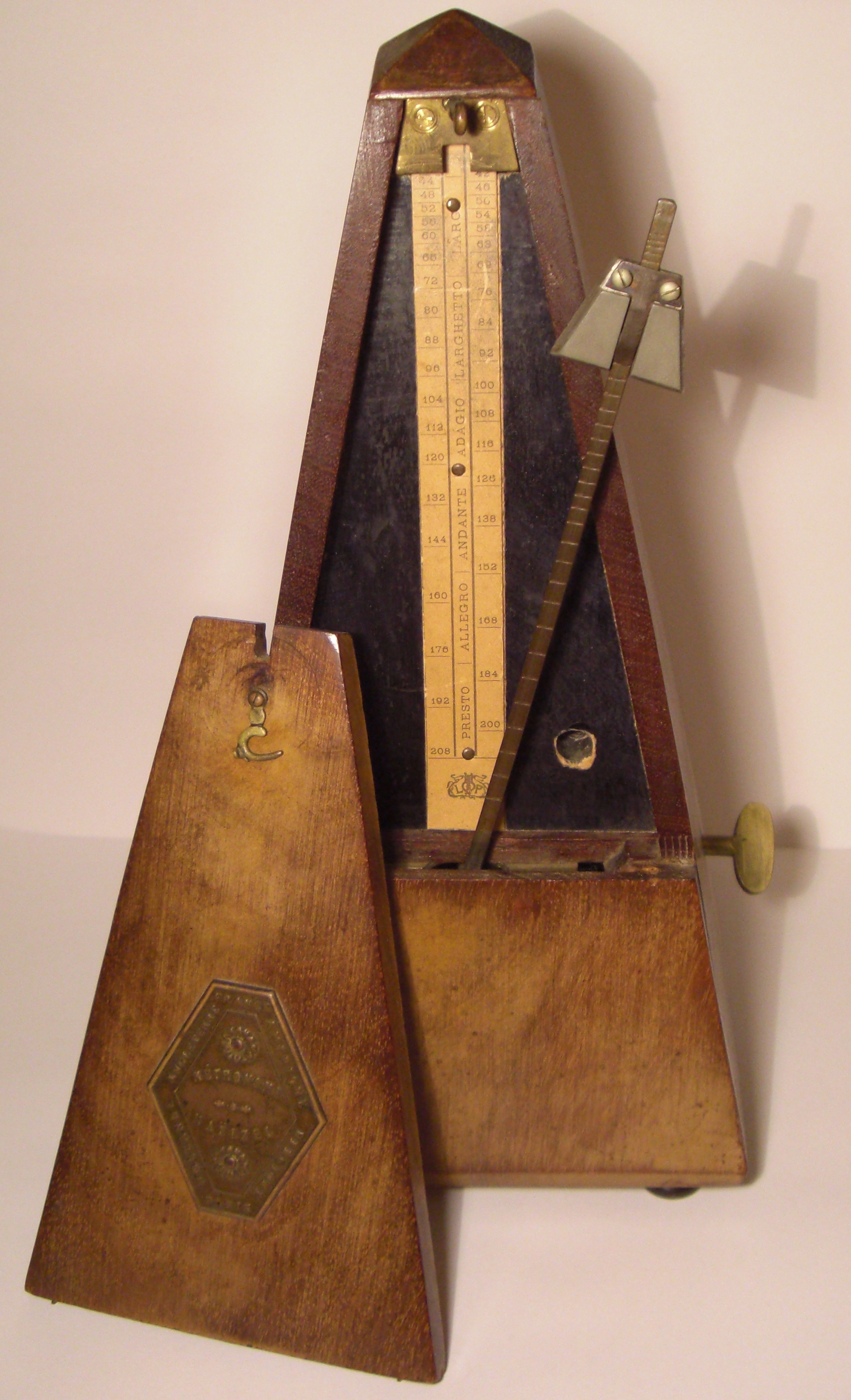 A mechanical metronome. Just as a metronome establishes tempo in music, a capital letter at the beginning of a sentence establishes the structural rhythm of a written thought.
