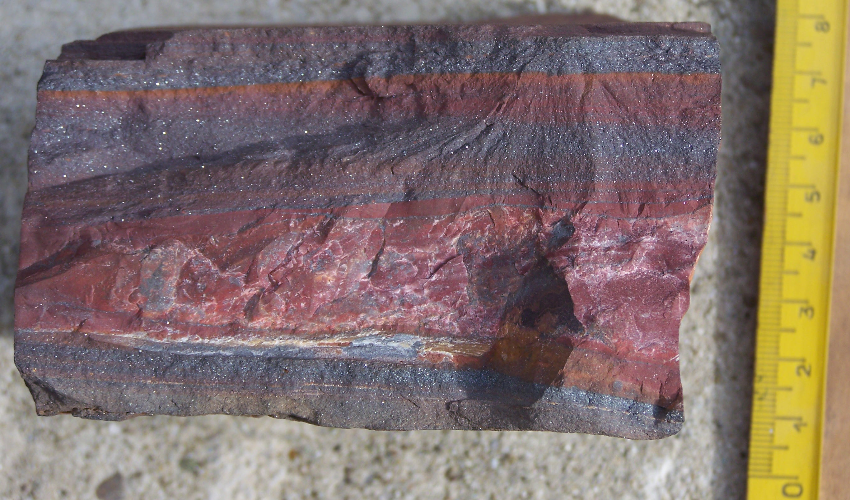 Alternating layers of iron oxide in banded iron formations provide the geological record of Earth's early oceans "rusting" as cyanobacteria produced the first free oxygen.