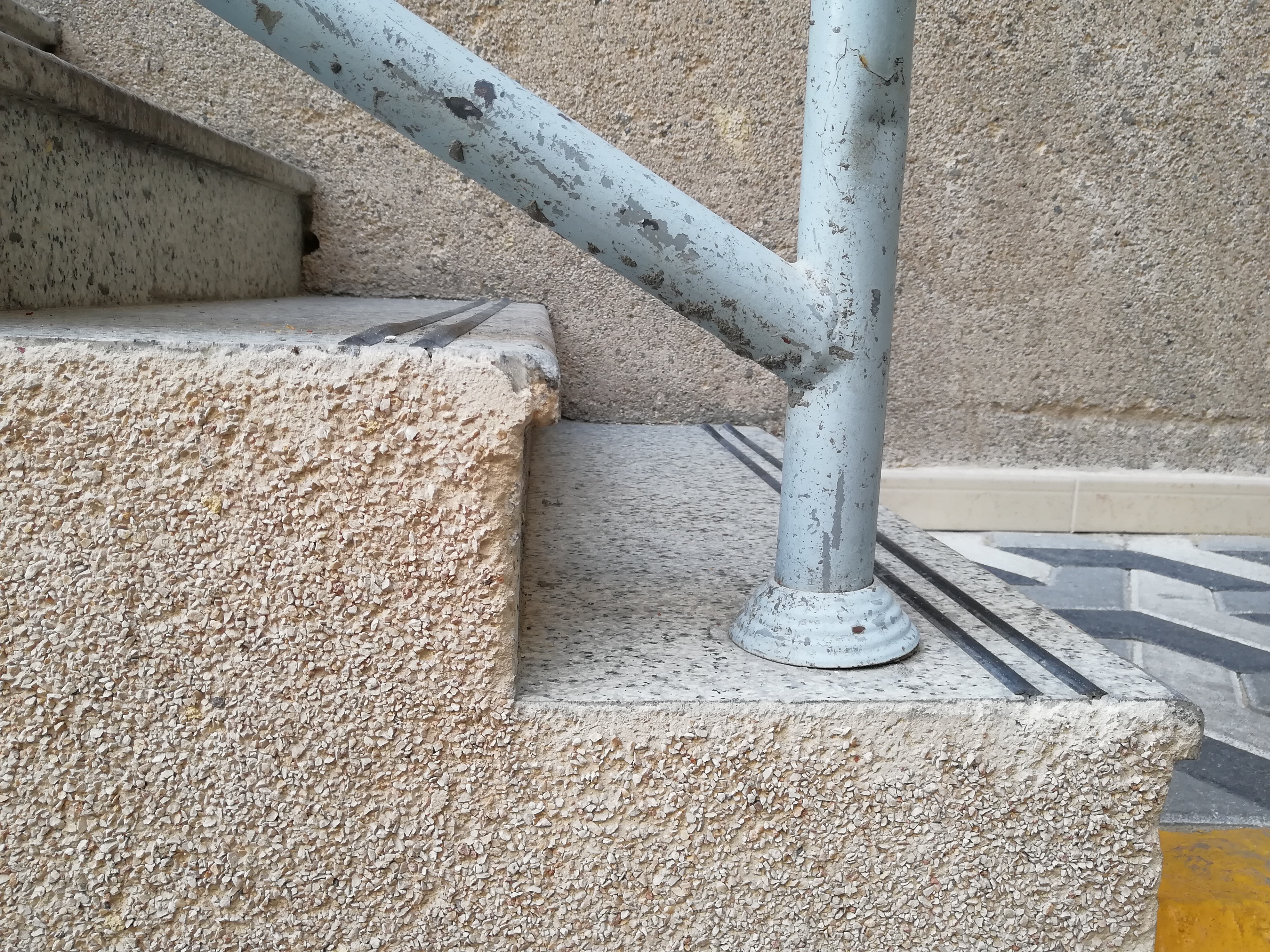 High-contrast tape or rubber strips applied to the edges of stairs create a stark visual boundary, mitigating the optical illusions that frequently cause falls among visually impaired clients.