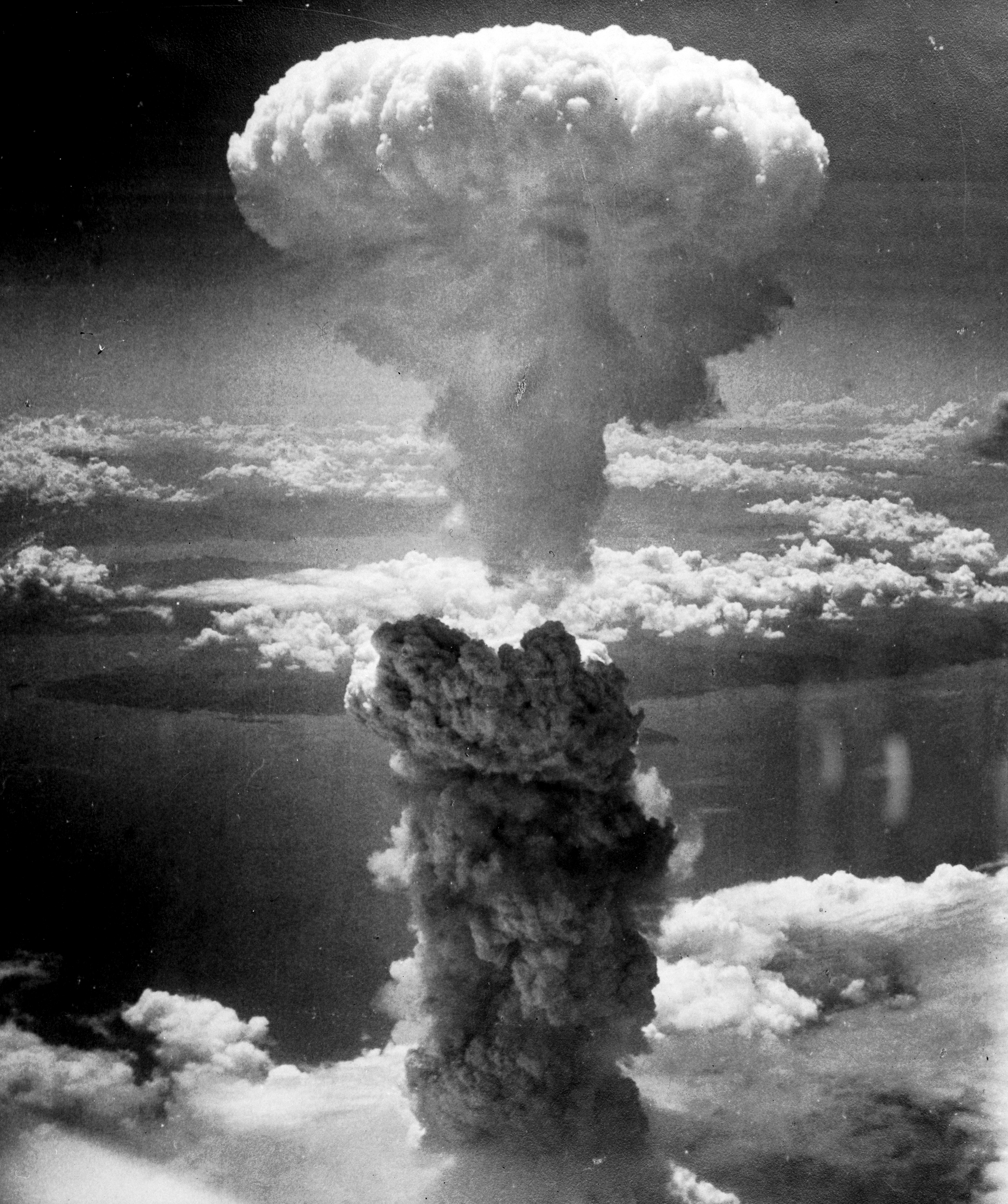The mushroom cloud over Nagasaki following the detonation of the second atomic bomb, leading to Japan's unconditional surrender.