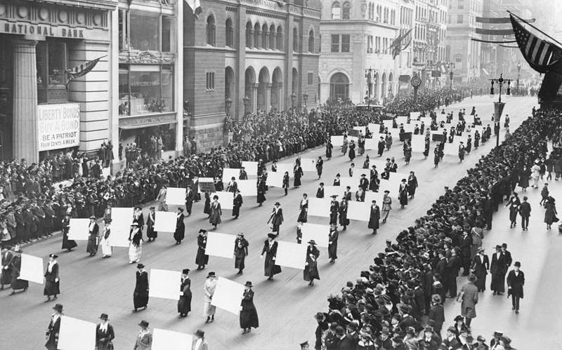 Suffragists marching down Fifth Avenue in New York City in 1917. Images of massive public organization demonstrate the highly visible, grassroots tactics required to finally secure the 19th Amendment.