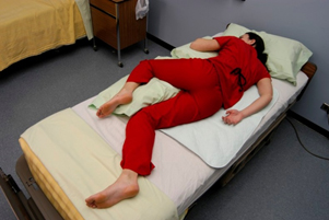 The Sims position, side-lying with the upper leg flexed, provides optimal physical access and stability for examining the rectum.
