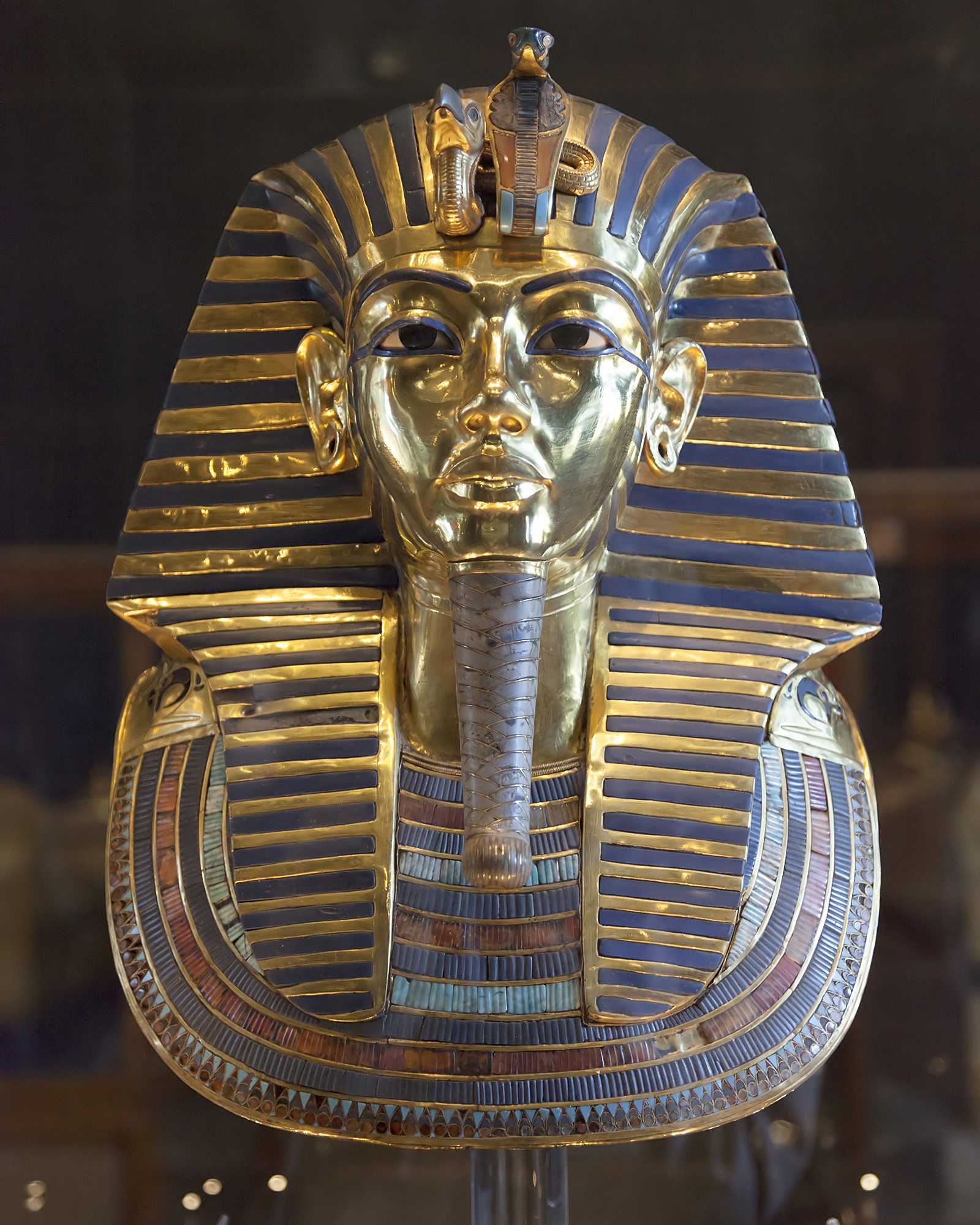 The golden funerary mask of Pharaoh Tutankhamun. As divine monarchs, pharaohs controlled vast wealth and were viewed as living gods tasked with maintaining cosmic order.